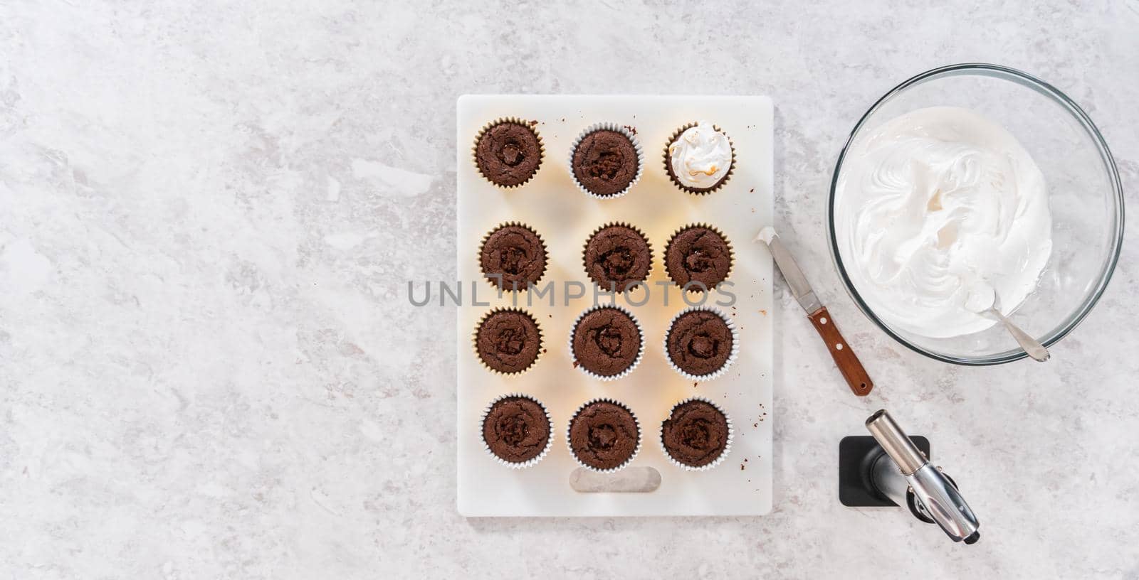 Flat lay. Frosting s'mores cupcakes with white meringue frosting.