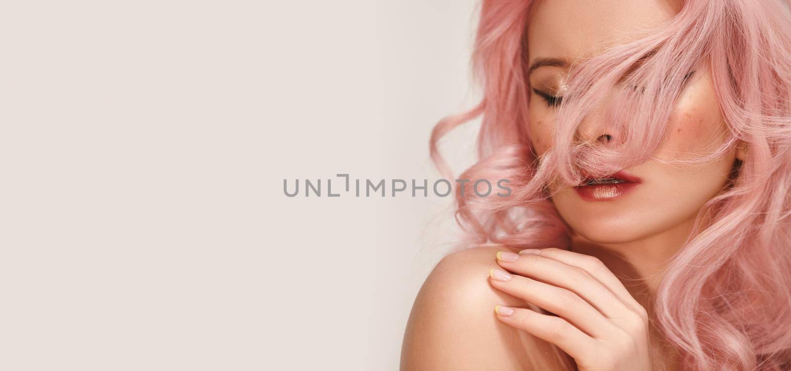 Soft-Girl Style with Trend Pink Flying Hair, Fashion Make-up. Woman Face with Fake Freckles and Rose Colored Hairstyle. Blonde Female Model with perfect Fresh Clean Skin, Blush Rouge
