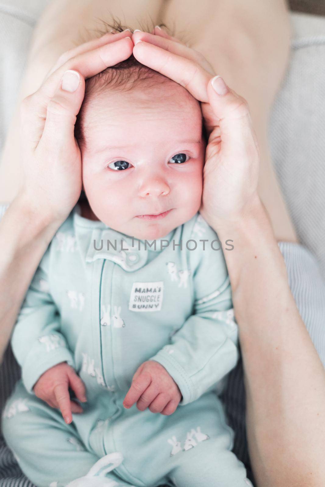 Lifestyle portrait of a newborn, three weeks old baby girl.