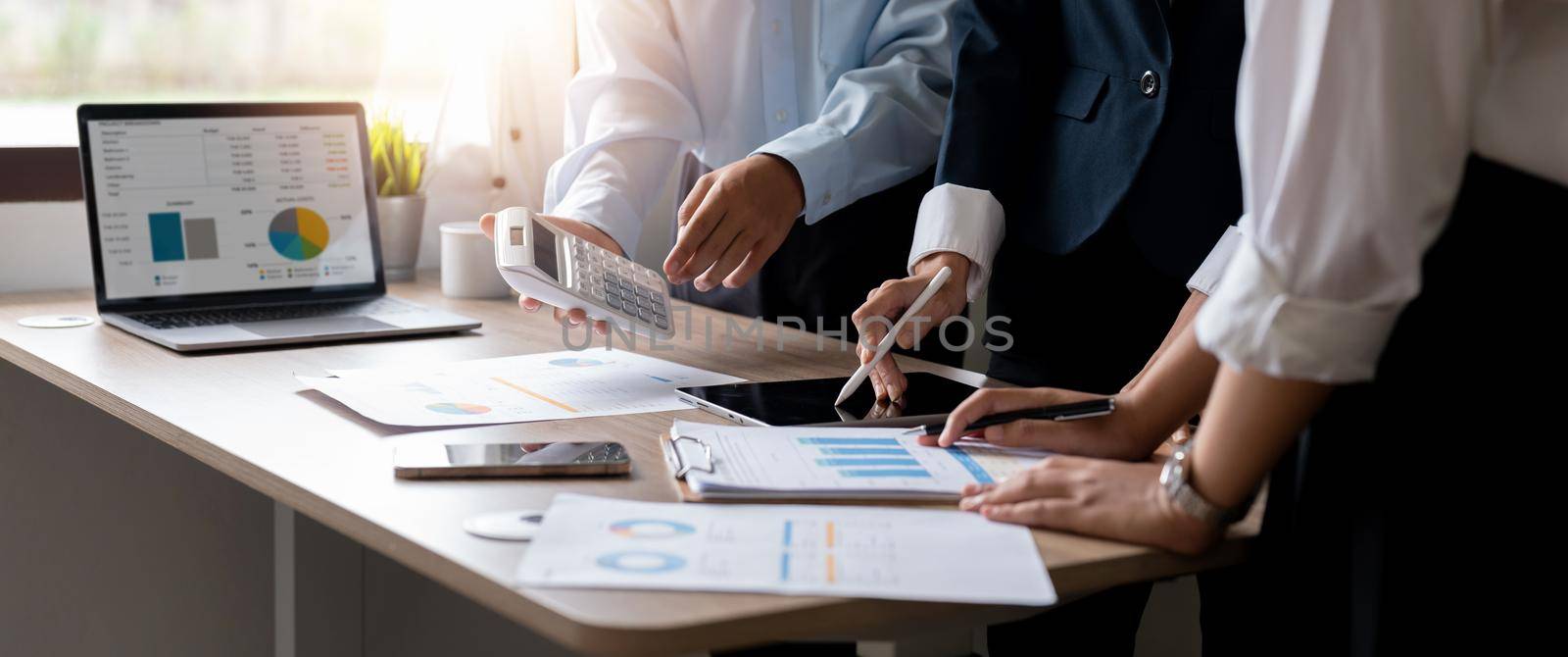 Businesspeople accounting analyzing investment graph meeting brainstorming and discussing marketing plan in meeting room, investment concept by nateemee