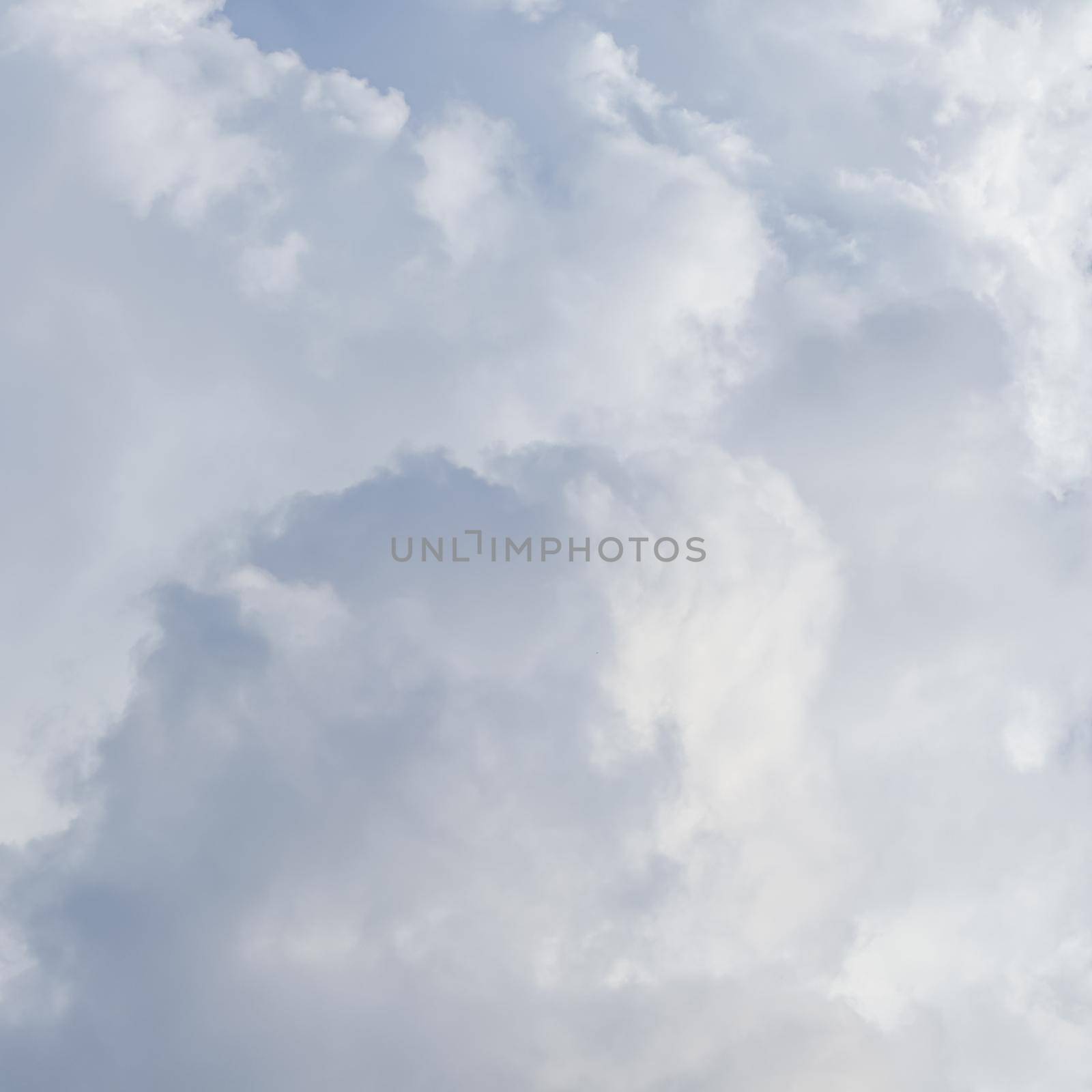 Cloudy sky background with sunlight shining through white clouds. Natural backdrop
