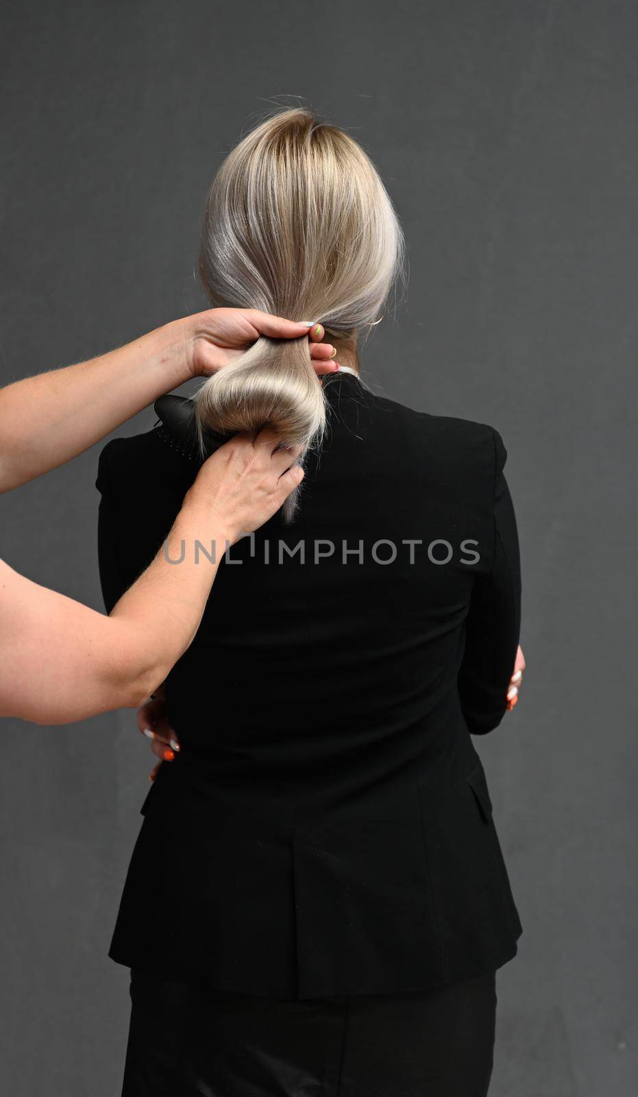 The hairdresser combs the model's hair from behind. Concept of recovery structure.