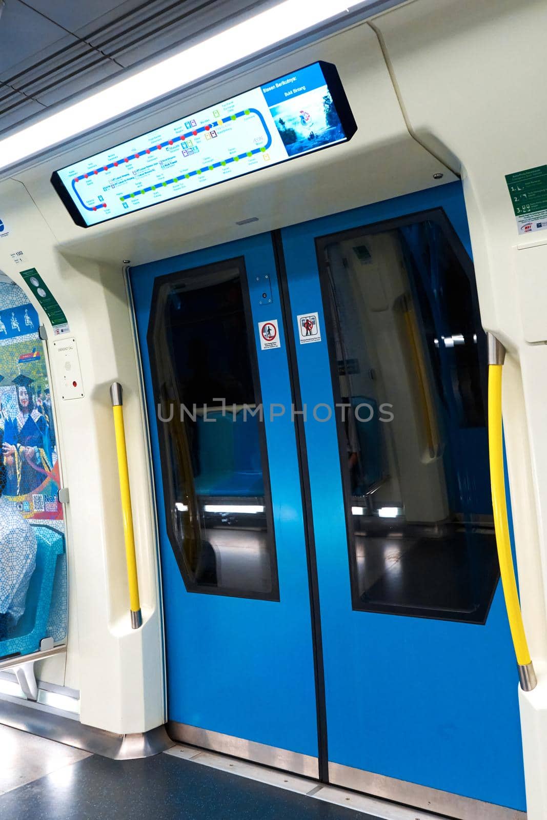 Lcd screen way map with stations above the doors in metro wagon. Kuala Lumpur, Malaysia - 04.01.2020