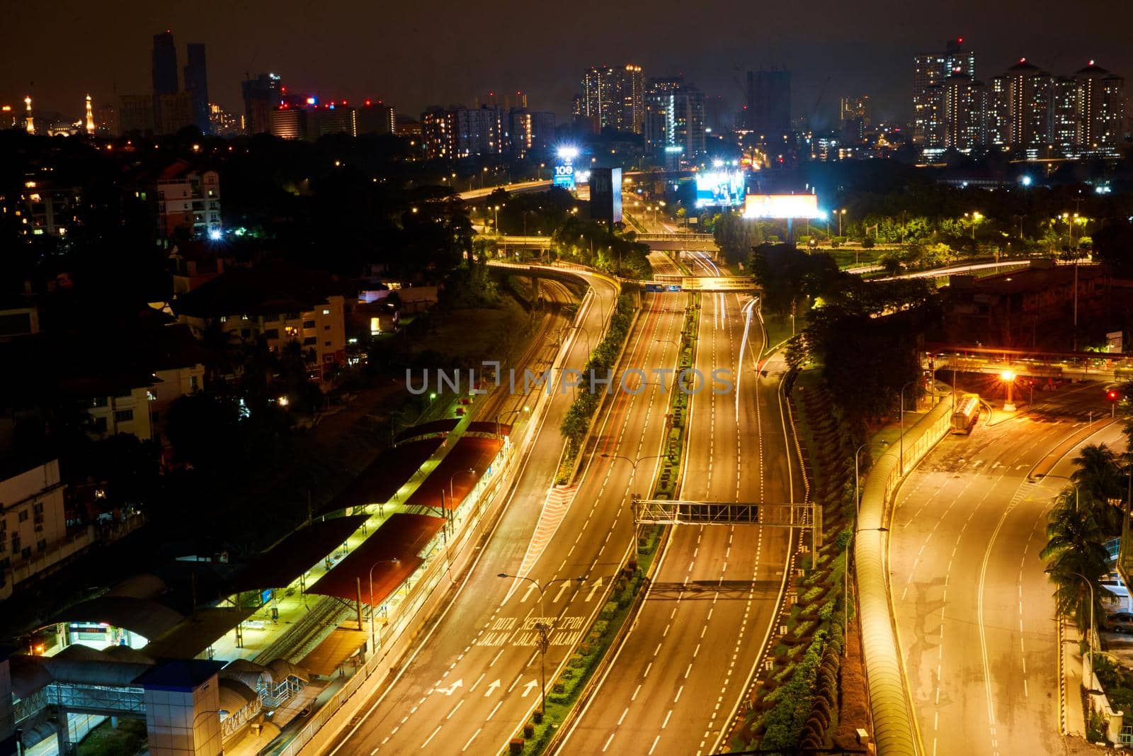 Multi-lane highway in the direction of the metropolis. Night view. Kuala Lumpur, Malaysia - 04.01.2020