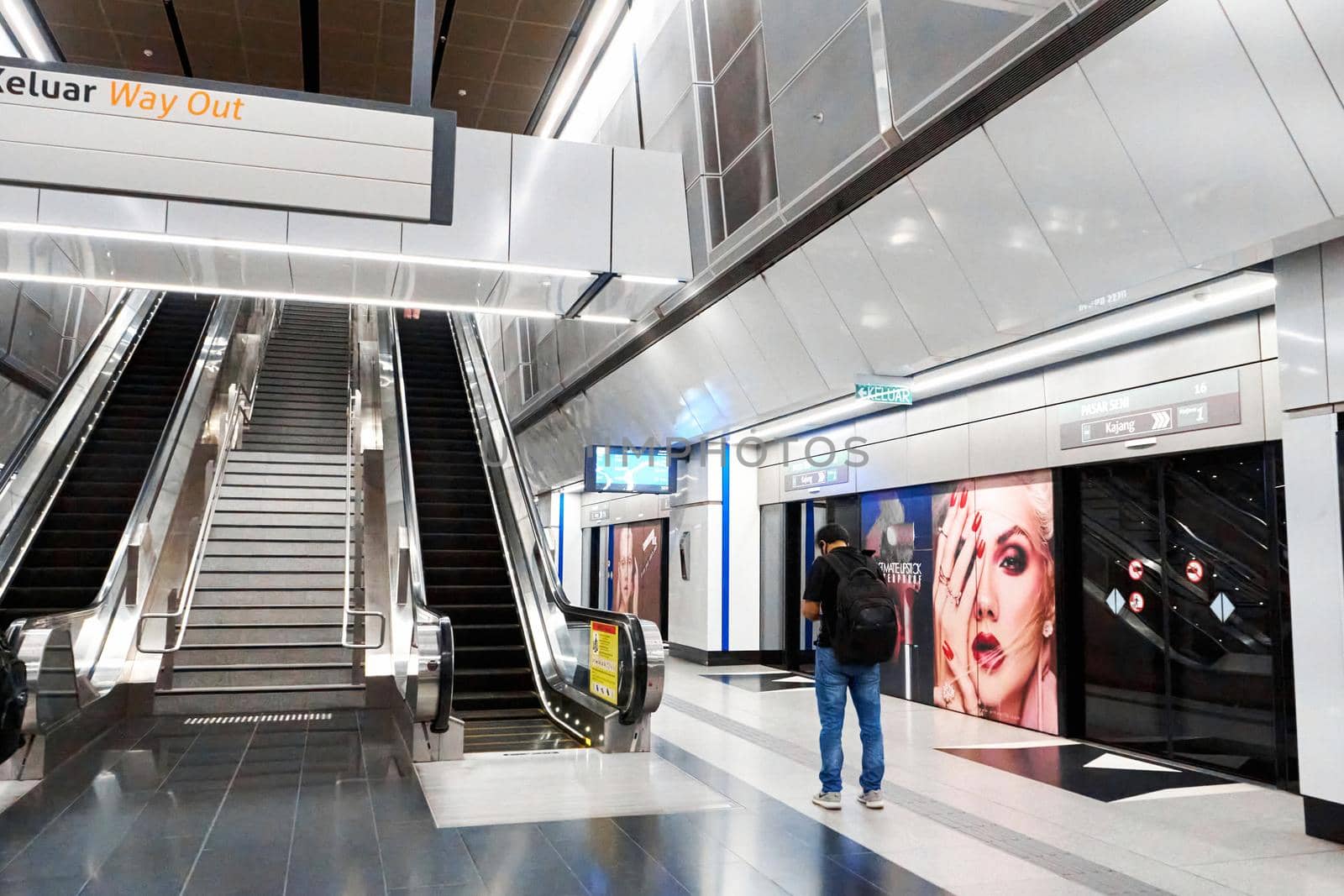 Huge modern escalator stair in the city mall. Kuala Lumpur, Malaysia - 04.01.2020