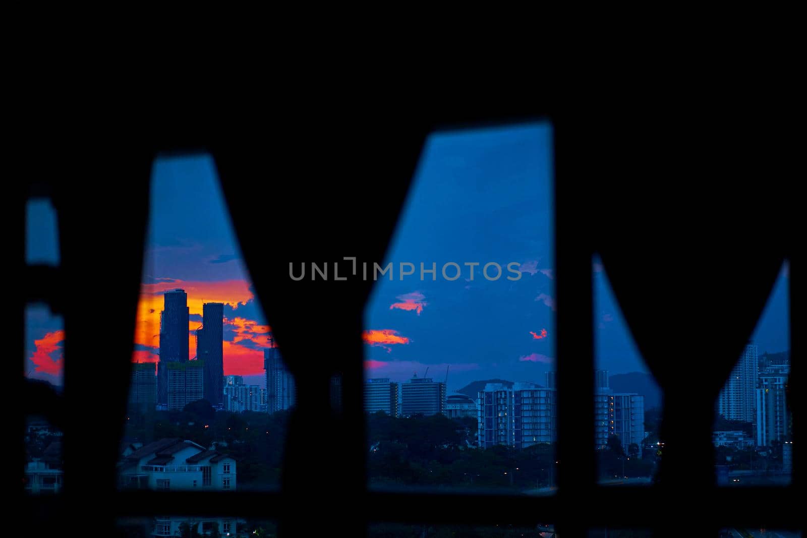 Evening sunset view from the window of the apartment on a multi-lane highway in the direction of the metropolis.