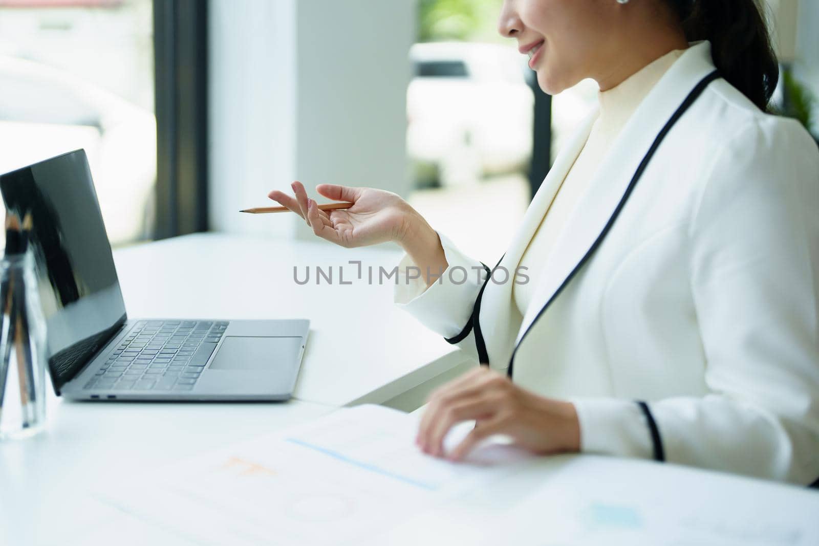 A portrait of a female employee using a computer video conferencing to discuss work through the Internet network.