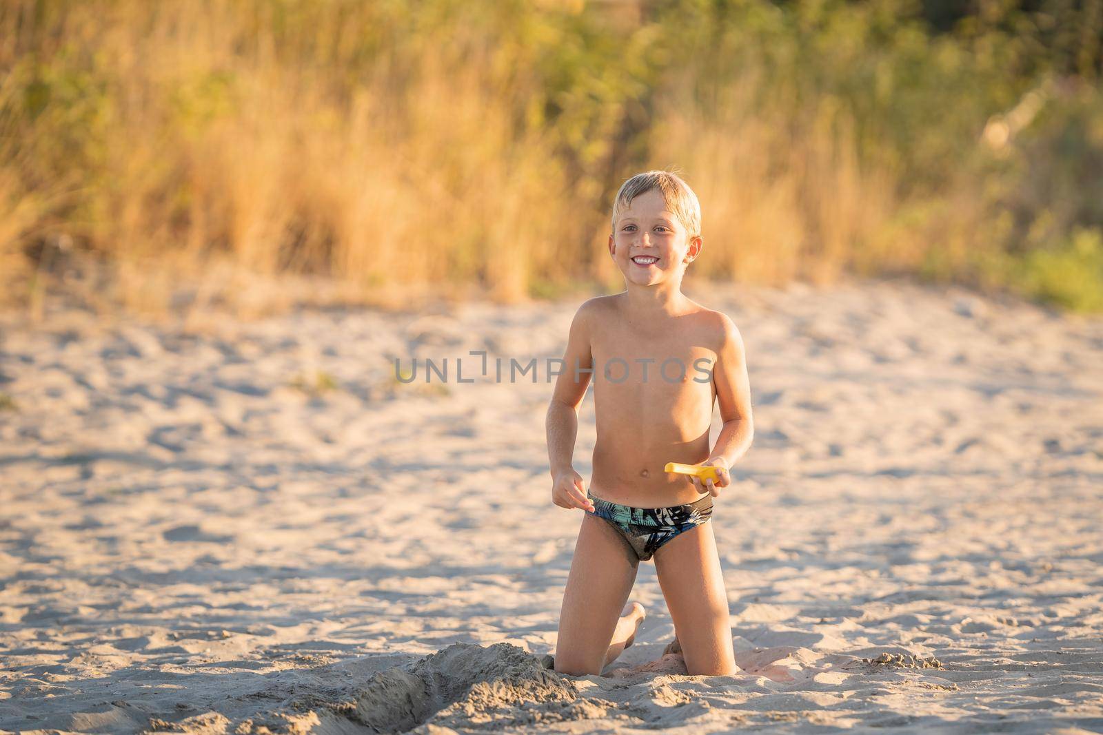 Portrait kid smiling on the beach summer holidays by Robertobinetti70