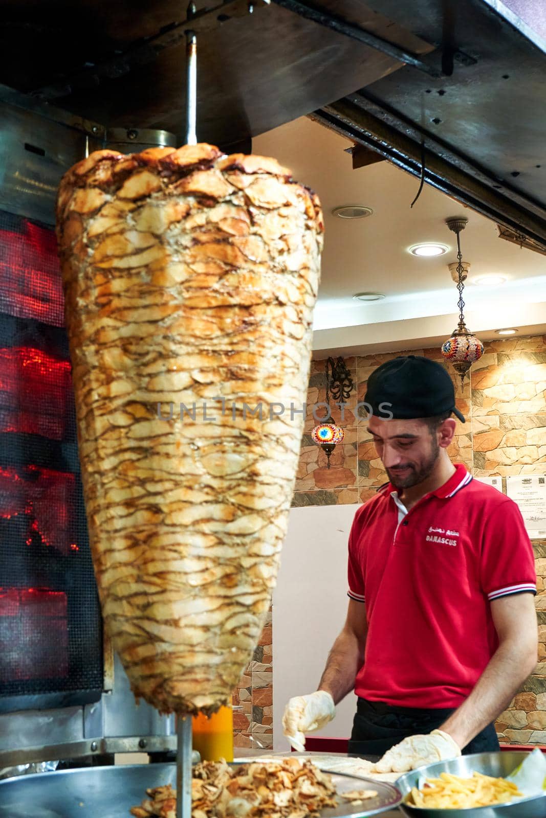 Shawarma street food counter. Meat frying on pole, while cooking. Kuala Lumpur, Malaysia - 04.01.2020
