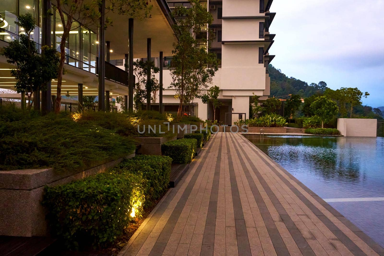 Exterior of modern condominium complex with swimming pool.