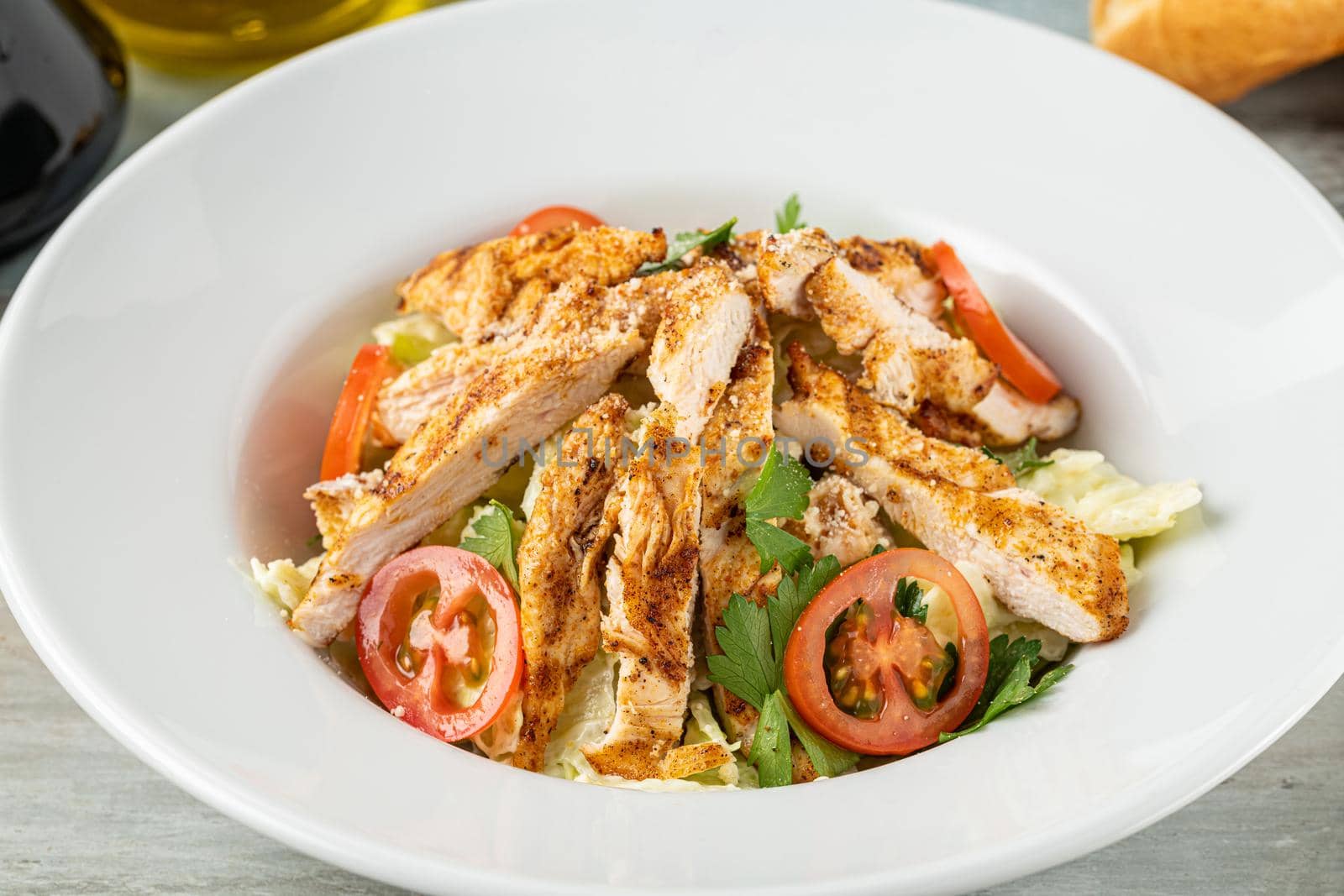 Fresh Mediterranean salad with grilled chicken breast. top view by Sonat