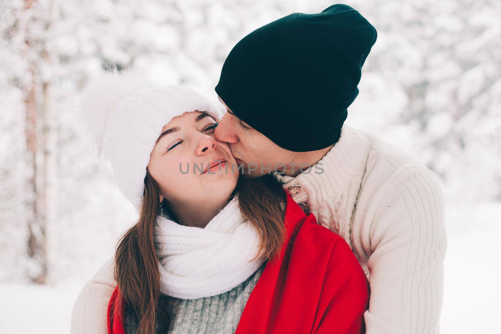 A couple in love in winter in the forest lifestyle . An article about love. An article about Valentine 's Day . by alenka2194