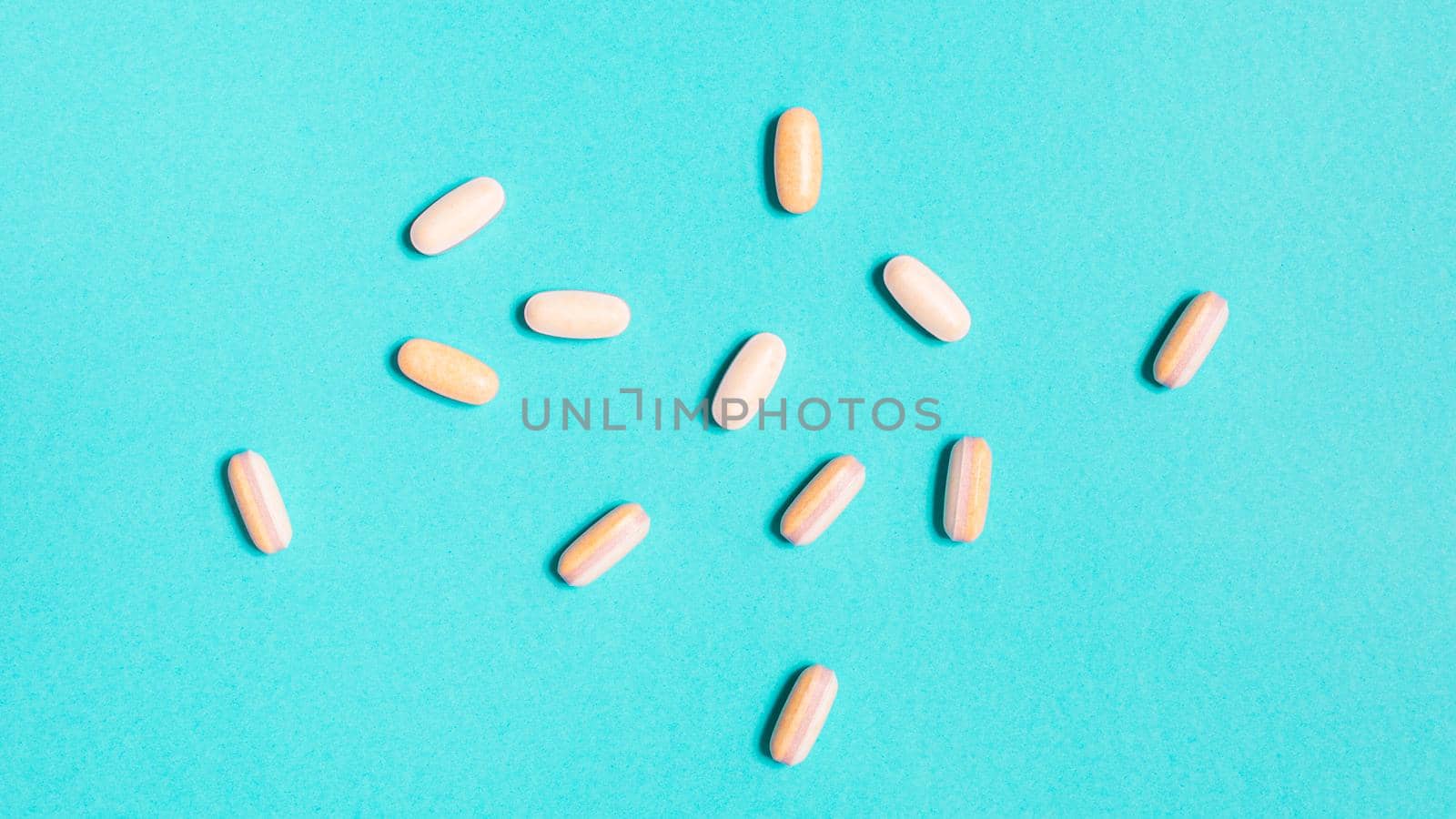 Tablets drugs therapy antibiotic on pastel blue background from above by Ciorba