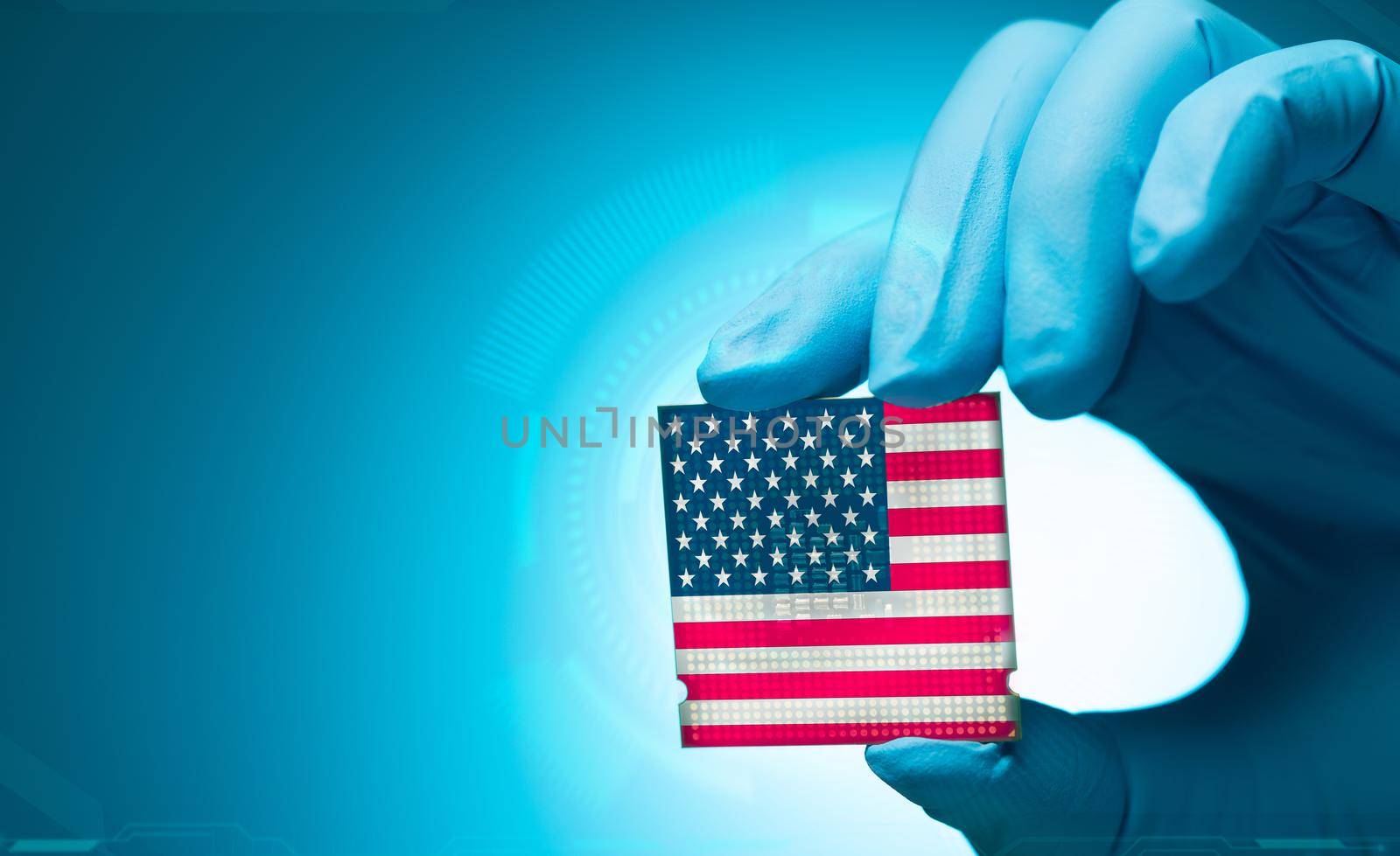 Electronic engineer hand holding computer chip with American flag on blue background. Chipset of electronic circuit board. CPU chip. Computer hardware. Computer processor chip. American computer chip. by Fahroni