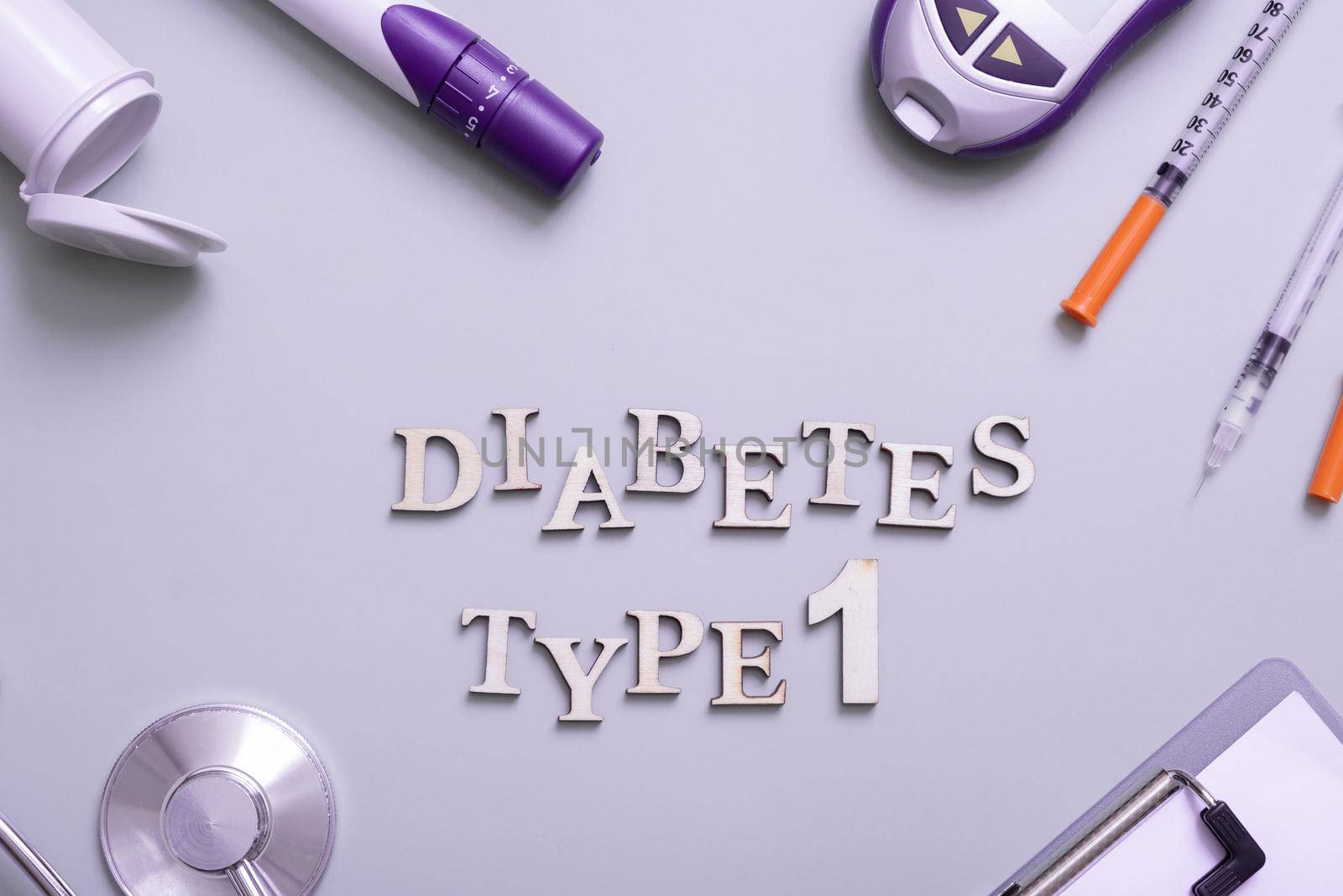 Inscription diabetes type 1 and glucometer, syringes and medical equipment on a colored background, top view by ssvimaliss