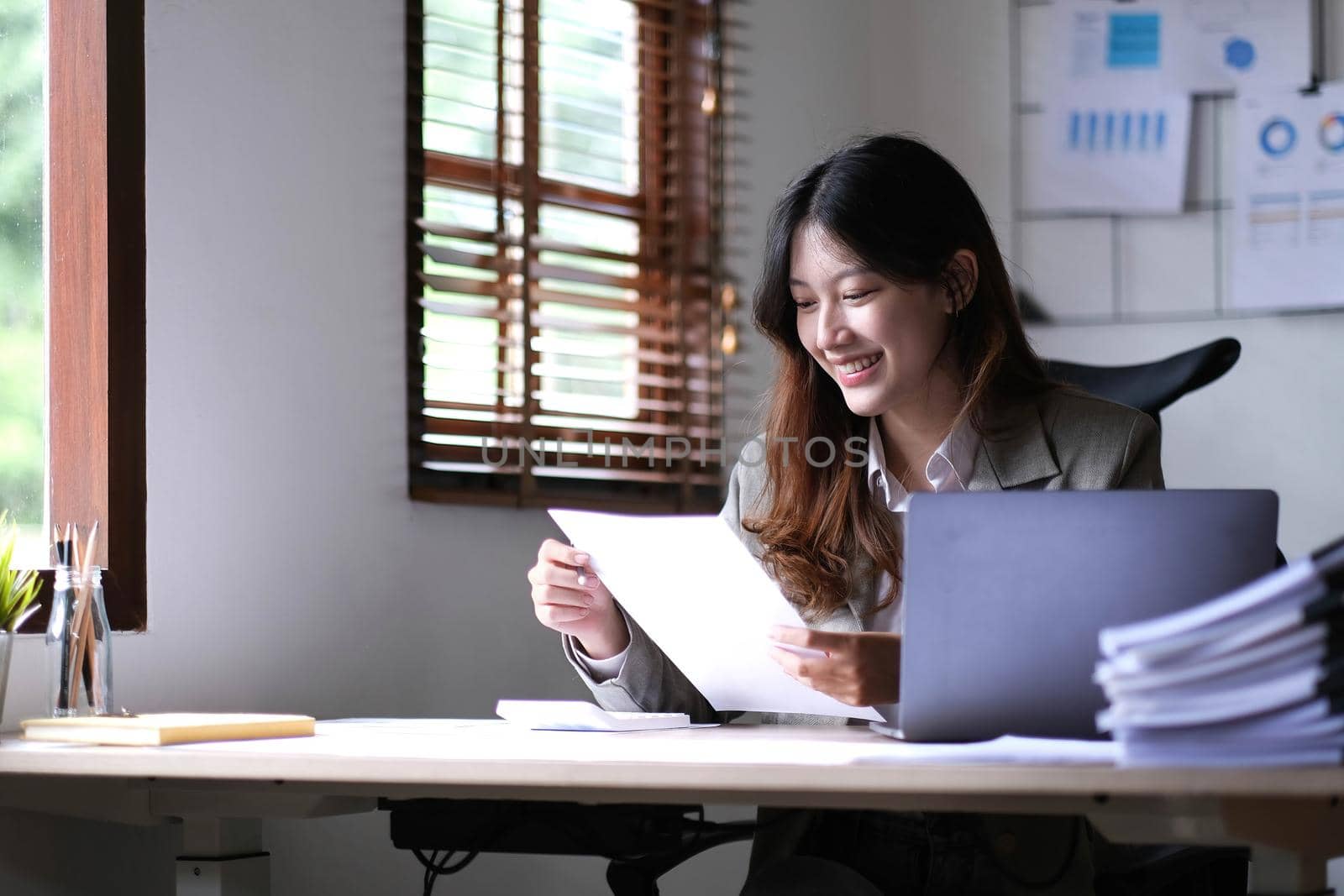 Asian businesswoman working in the office with working documents..