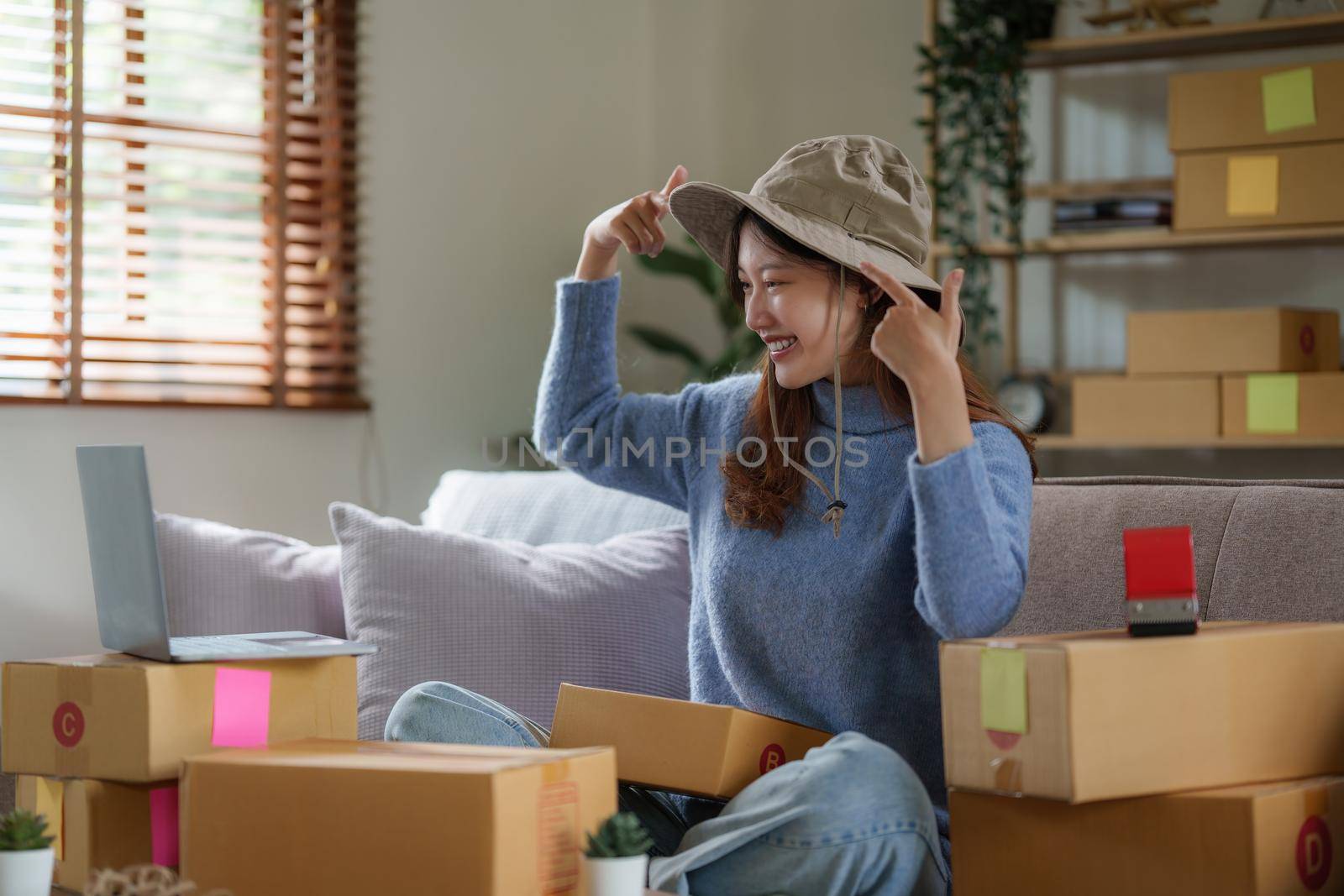 Asian SME business woman working at home office. online shopping concept.