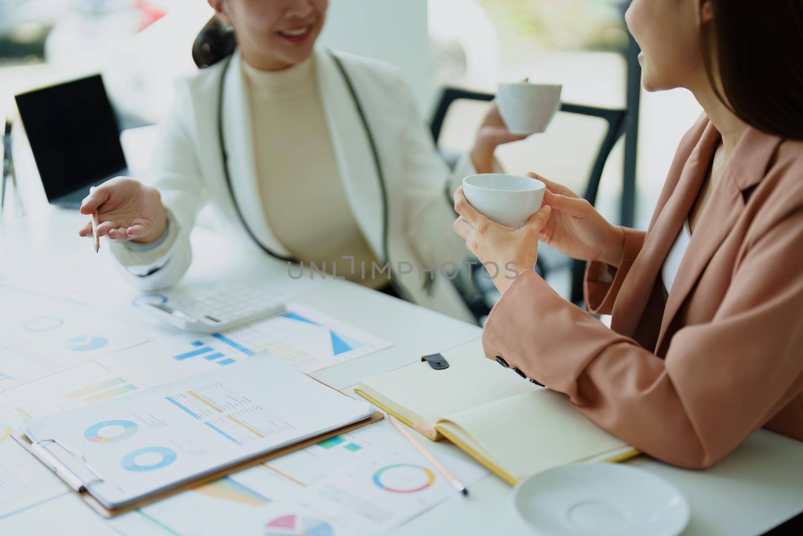 female marketing and sales employee talking and taking a coffee break