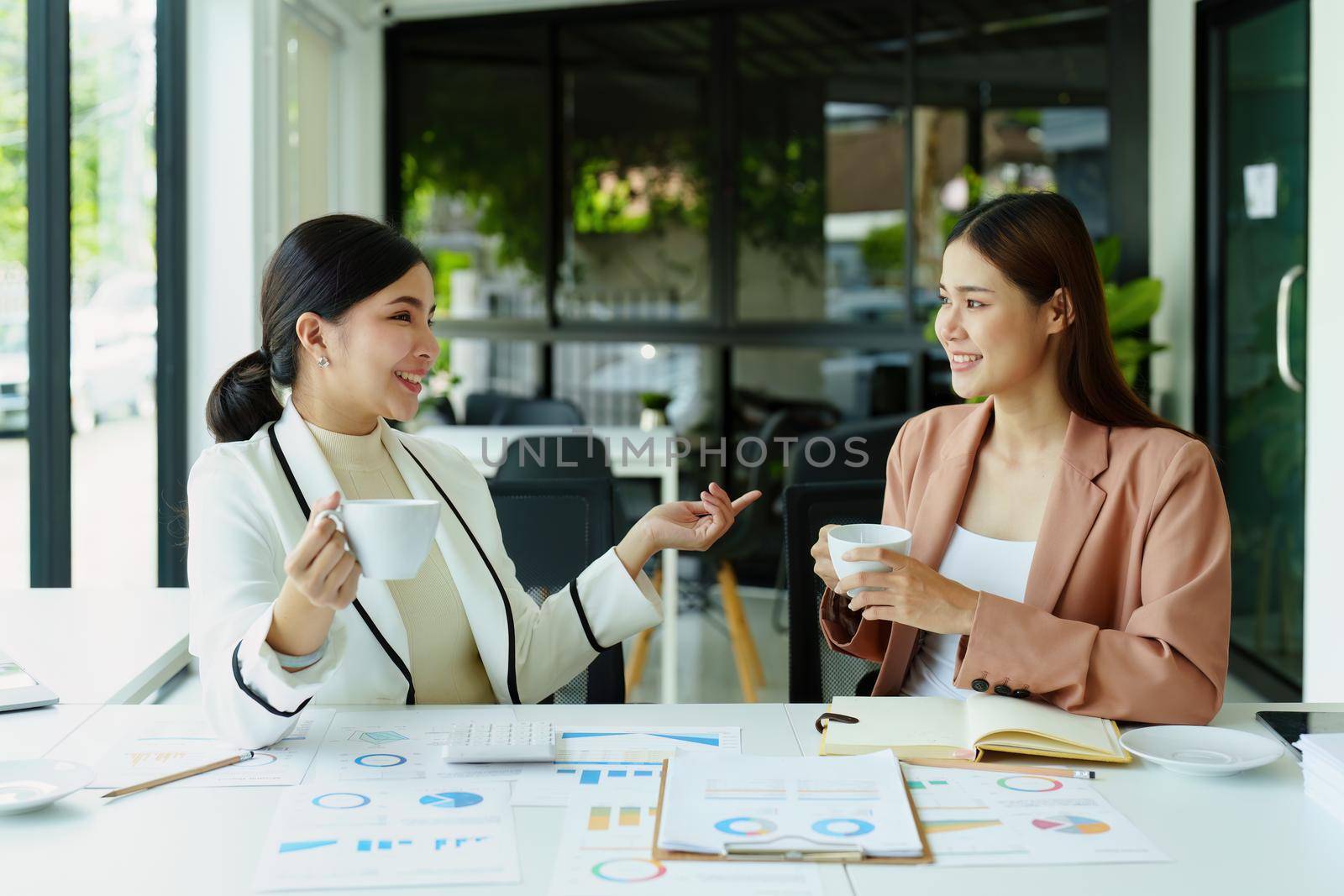 female marketing and sales employee talking and taking a coffee break