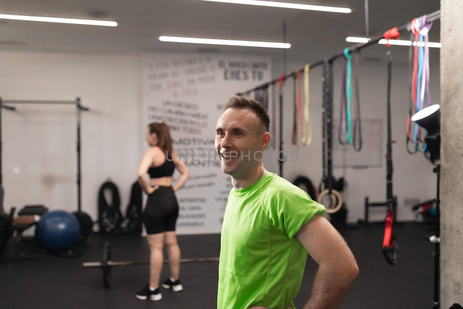 Portrait of a male trainee smiling while resting during a workout session at the crossfit box