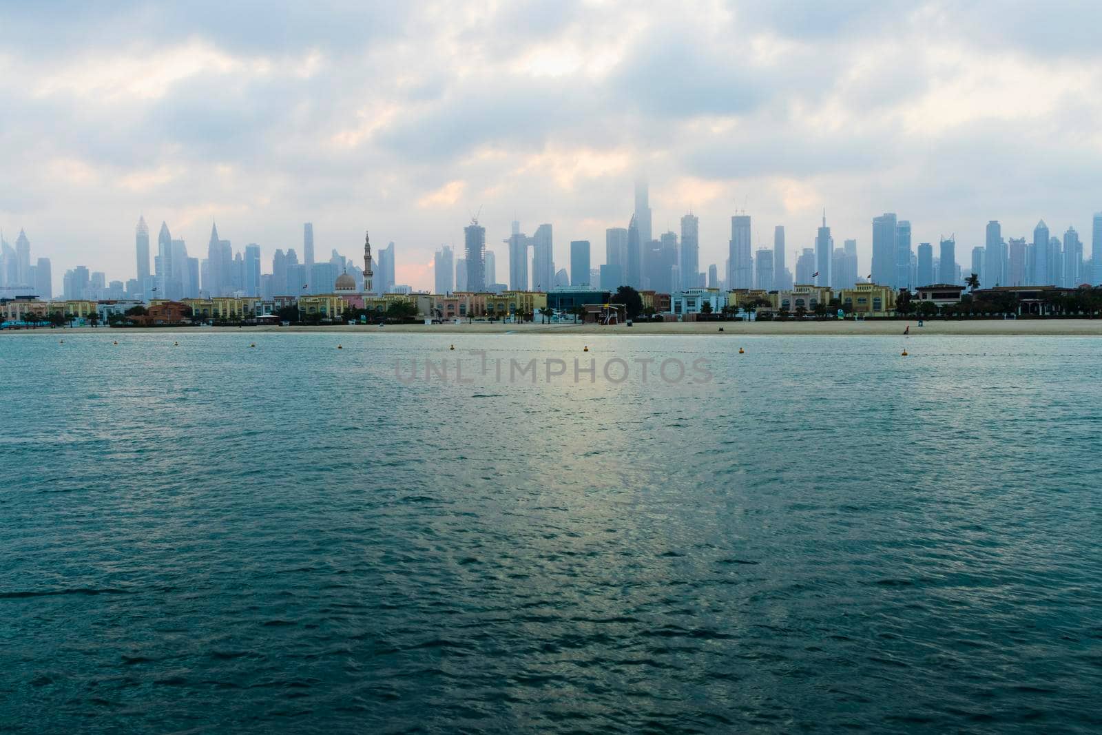 Dubai, UAE - 03.06.2021 Dubai public beach with city skyline on background.Sunrise hour