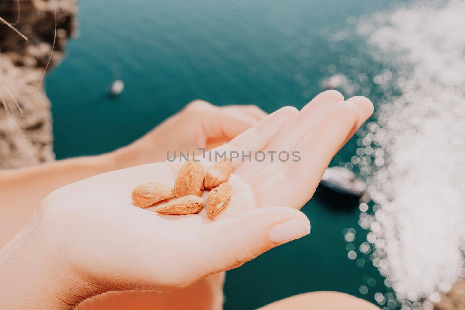 Unrecognizable caucasian woman eating young milky almond nuts. Healthy vegan food