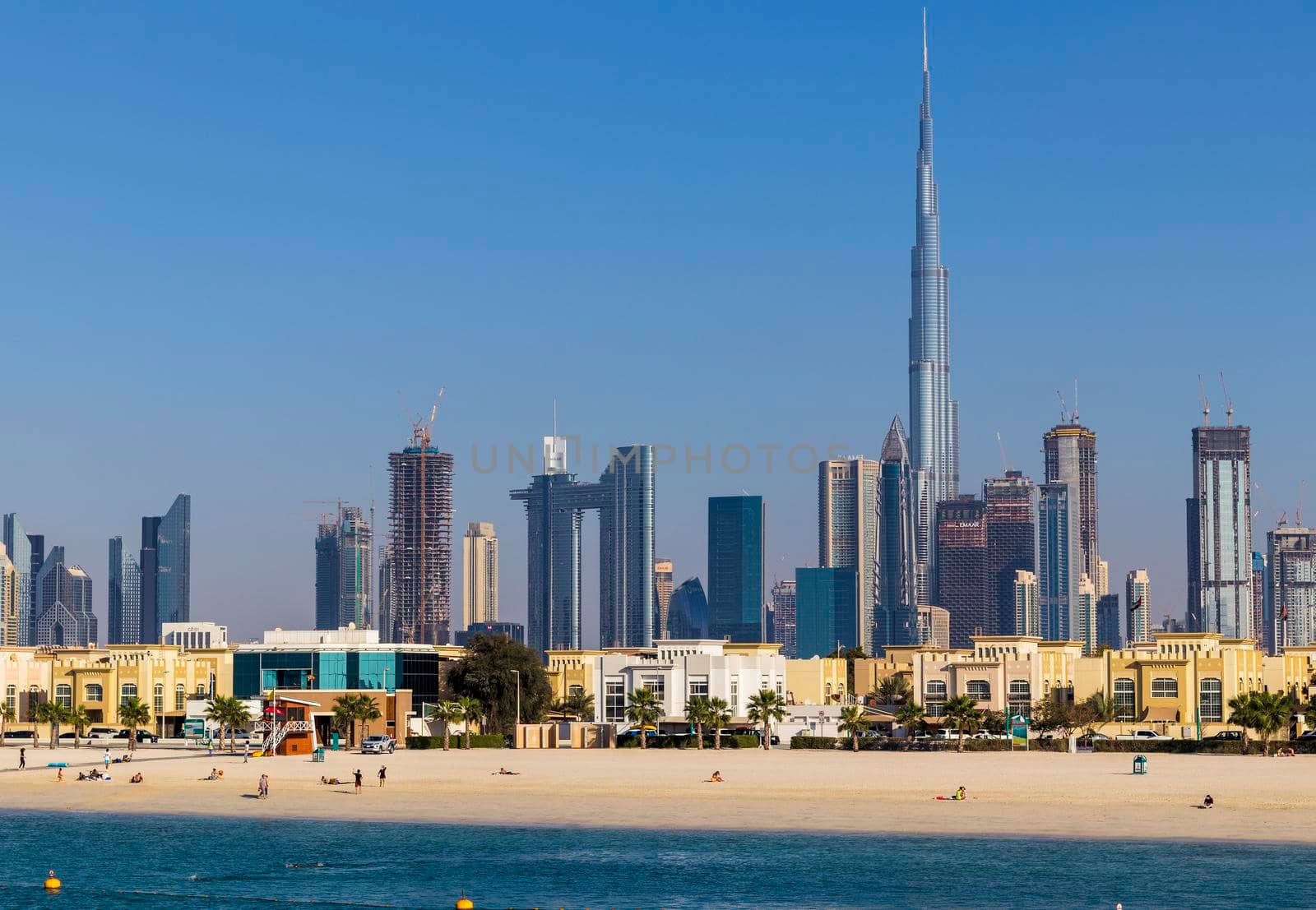 Dubai, UAE - 02.27.2021 Dubai public beach with city skyline on background. Outdoors by pazemin