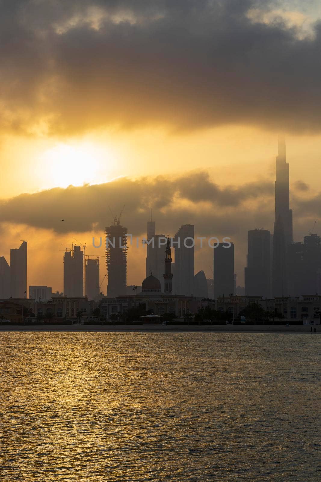 Dubai, UAE - 03.06.2021 Dubai public beach with city skyline on background.Sunrise hour