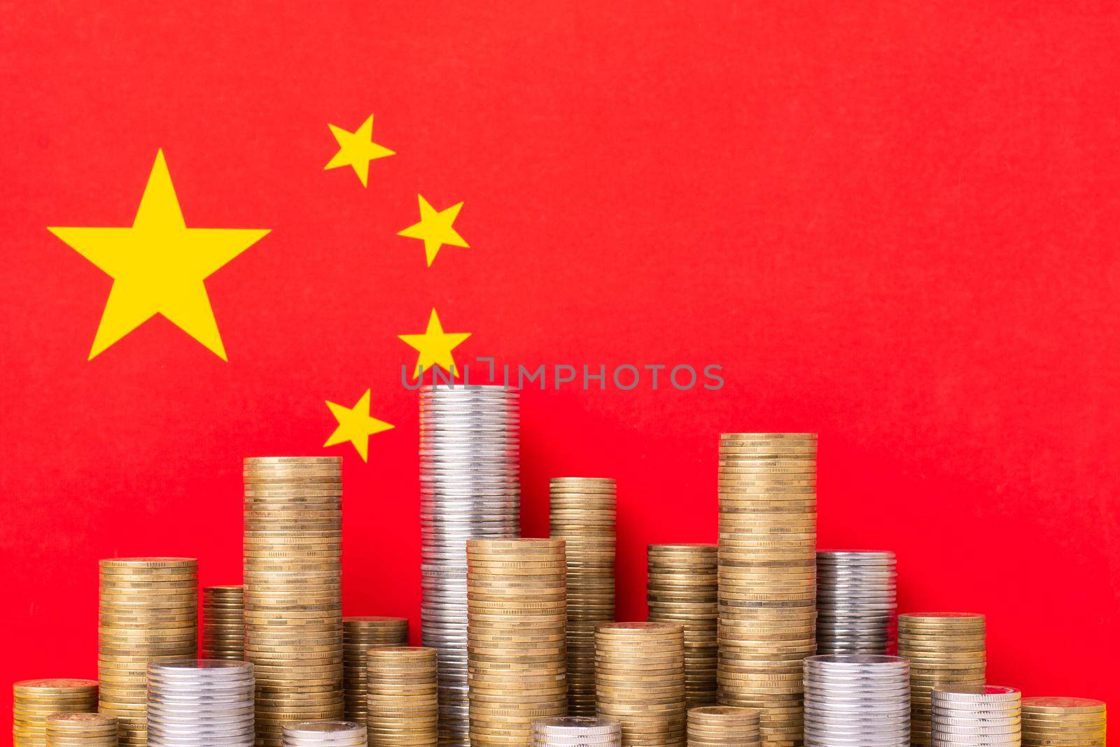 Flag of China with stacks of gold and silver coins by VitaliiPetrushenko
