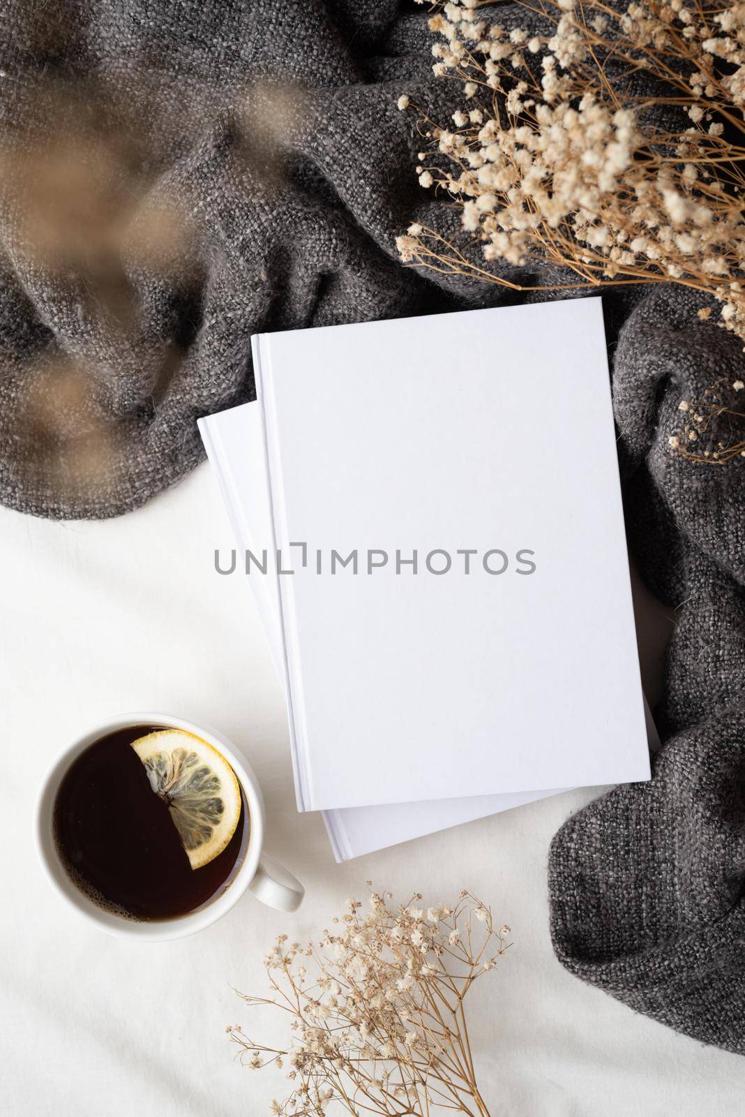 white blank books with gray plaid, cup of lemon tea and dry flowers , mockup design by Desperada