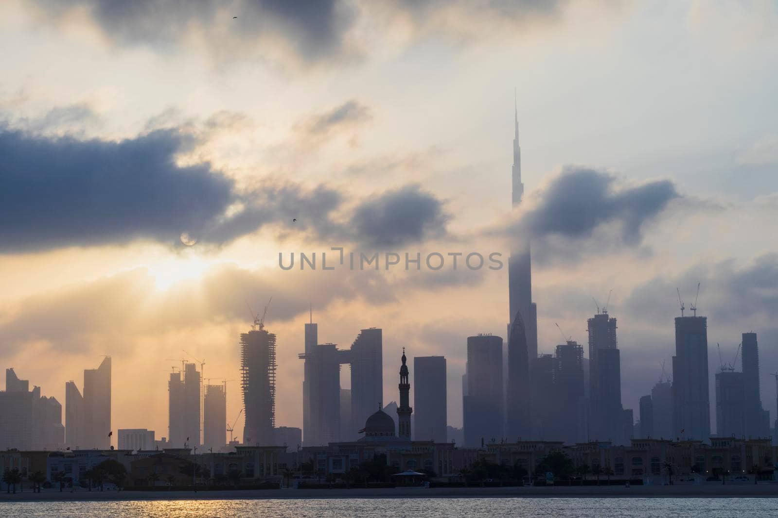 Dubai, UAE - 03.06.2021 Dubai public beach with city skyline on background.Sunrise hour. Outdoor by pazemin