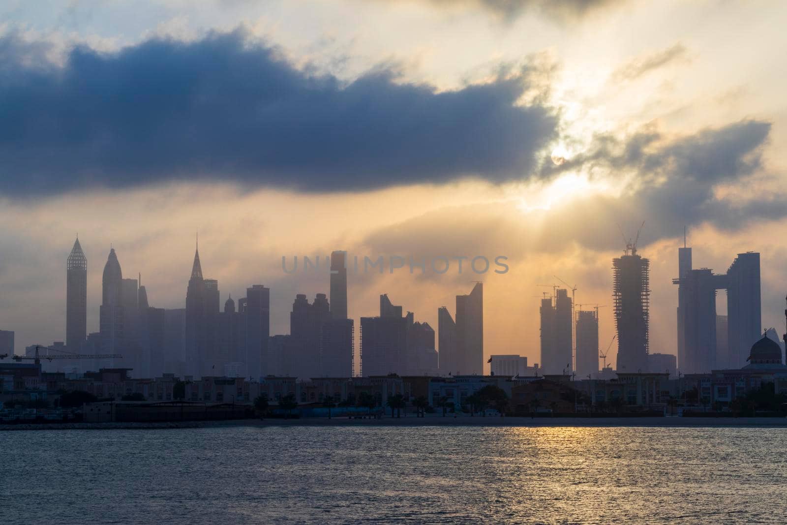 Dubai, UAE - 03.06.2021 Dubai public beach with city skyline on background.Sunrise hour