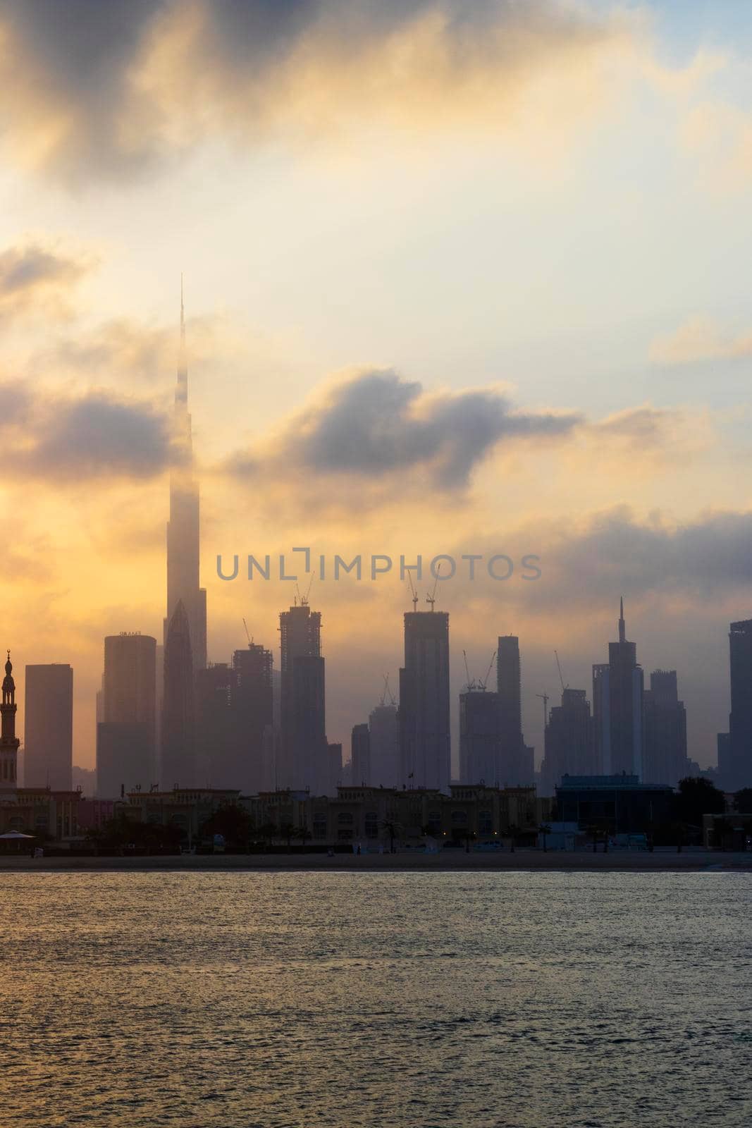 Dubai, UAE - 03.06.2021 Dubai public beach with city skyline on background.Sunrise hour