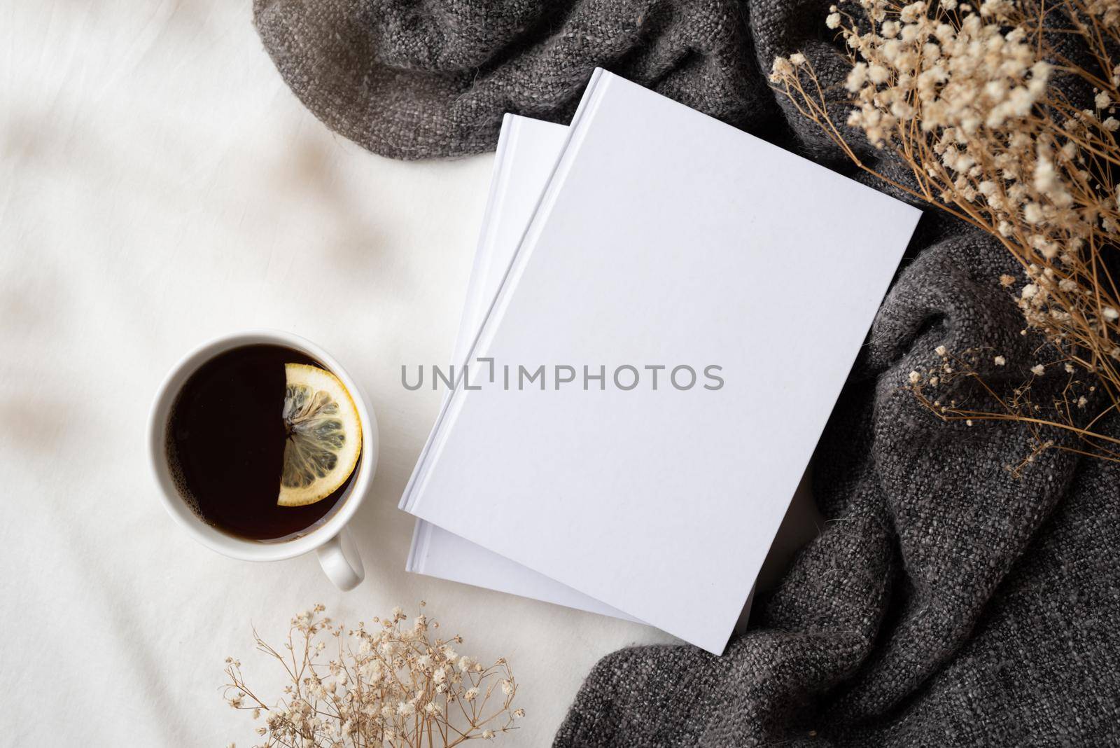 Back to school. Cozy autumn. white blank books with gray plaid, cup of lemon tea and dry flowers , mockup design