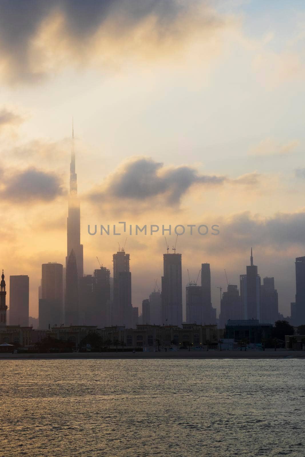 Dubai, UAE - 03.06.2021 Dubai public beach with city skyline on background.Sunrise hour. Outdoor by pazemin