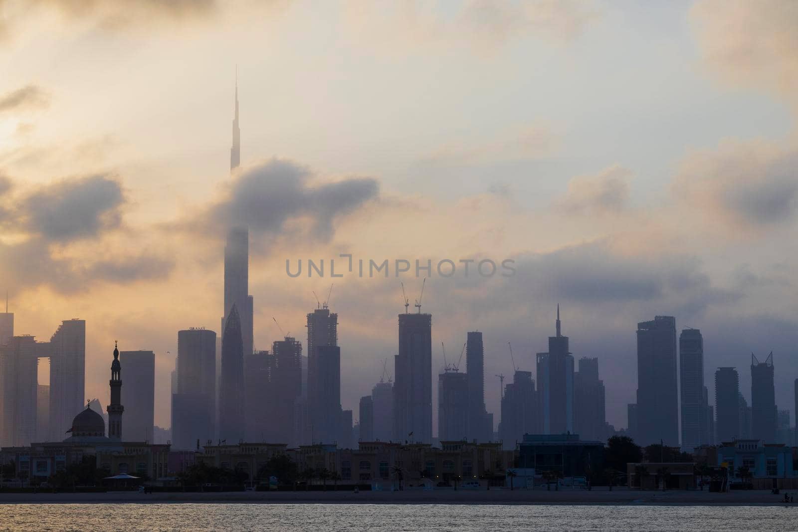 Dubai, UAE - 03.06.2021 Dubai public beach with city skyline on background.Sunrise hour