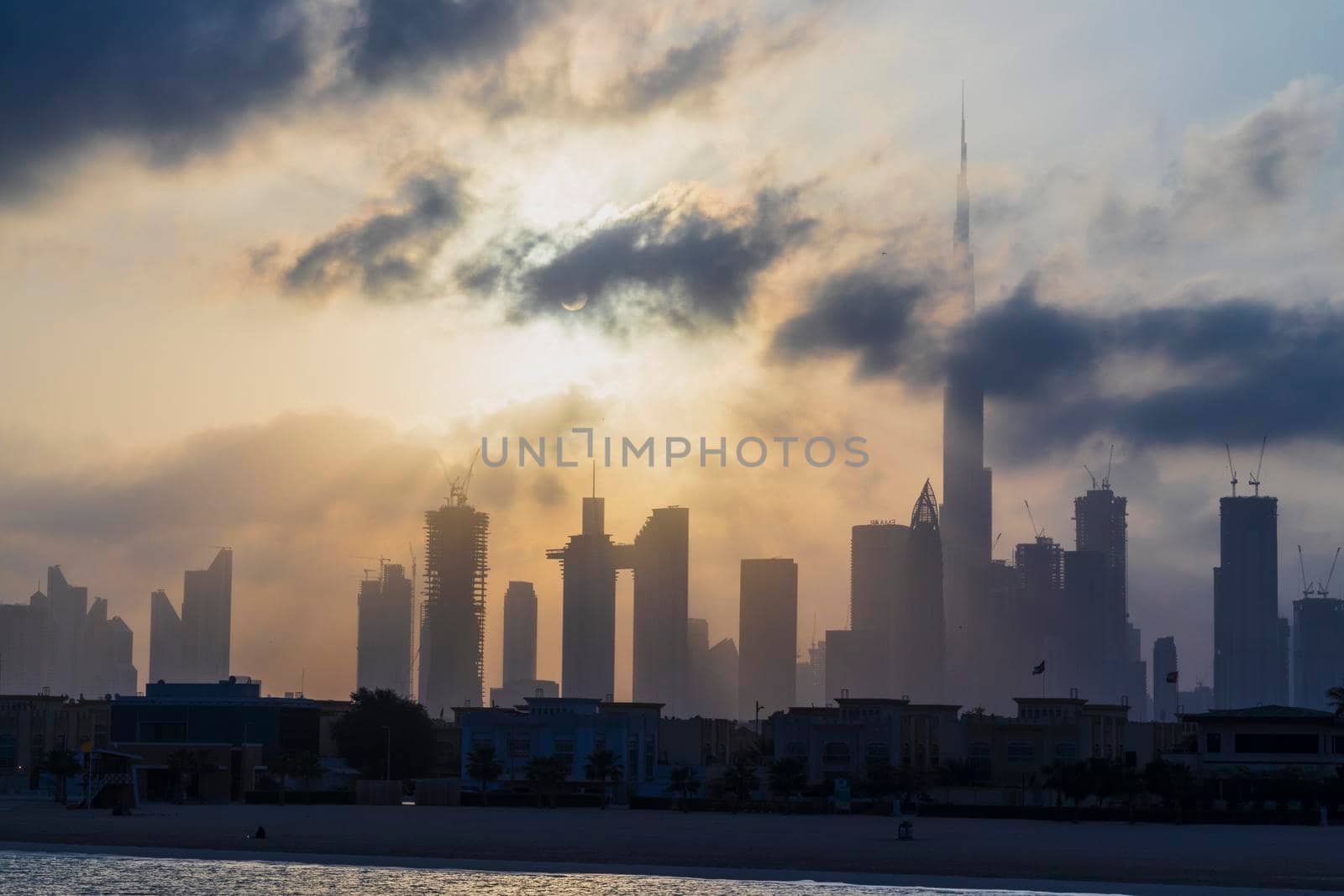 Dubai, UAE - 03.06.2021 Dubai public beach with city skyline on background.Sunrise hour