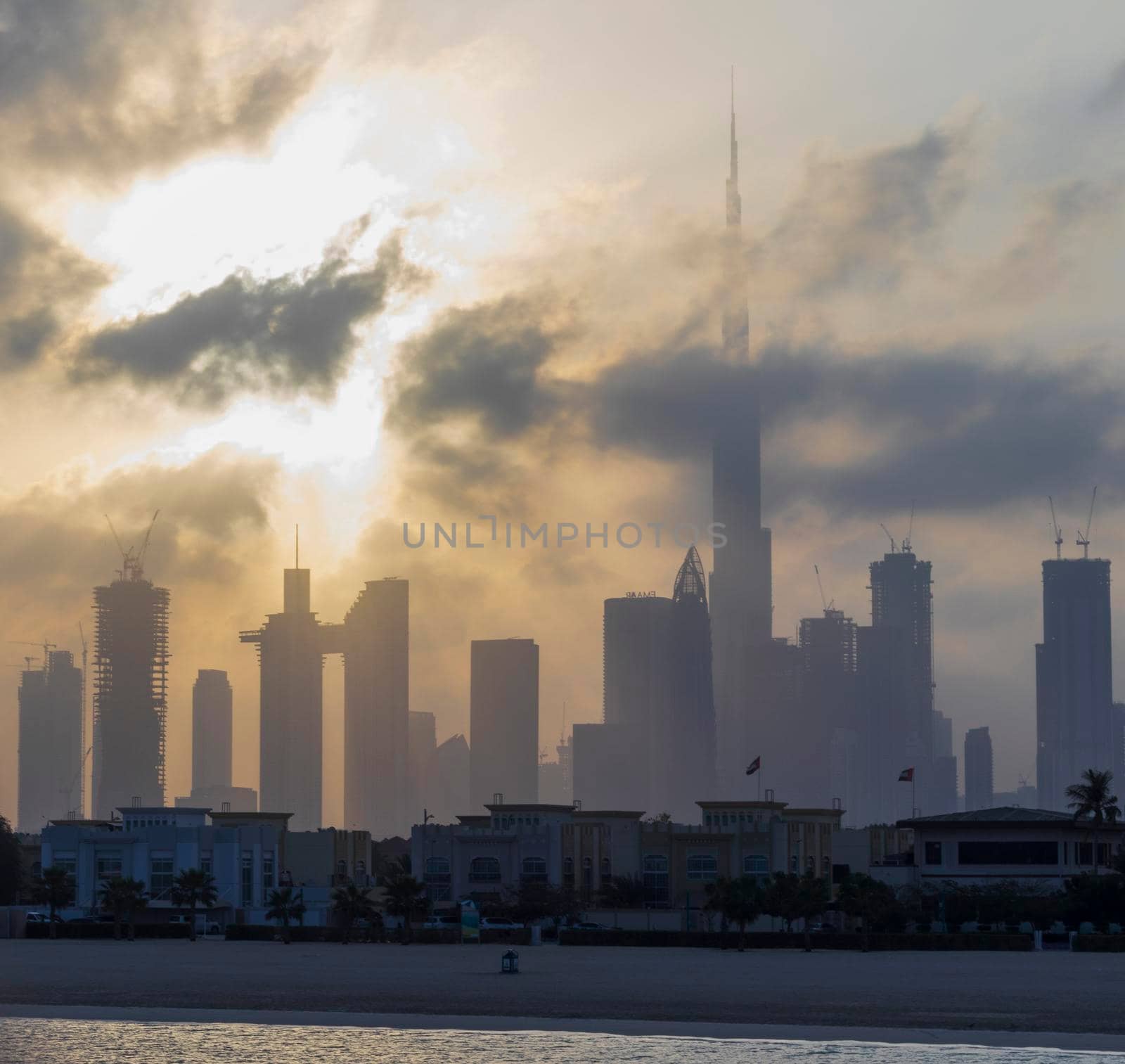 Dubai, UAE - 03.06.2021 Dubai public beach with city skyline on background.Sunrise hour. Outdoor by pazemin