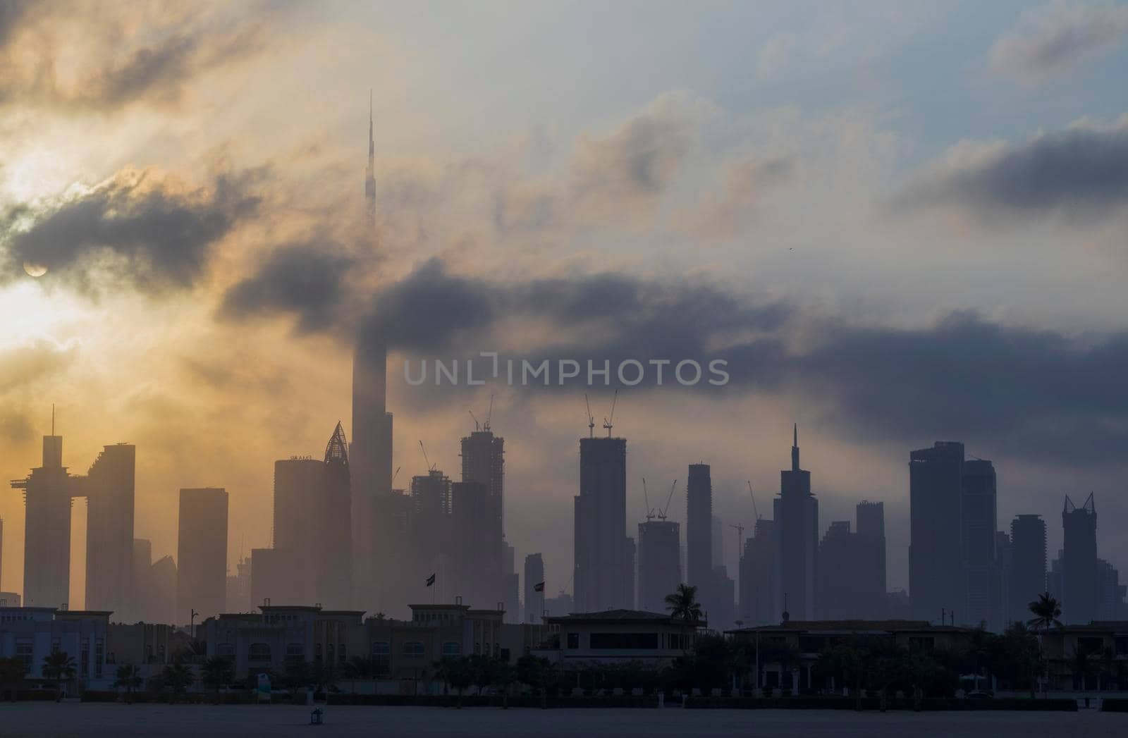 Dubai, UAE - 03.06.2021 Dubai public beach with city skyline on background.Sunrise hour. Outdoor by pazemin