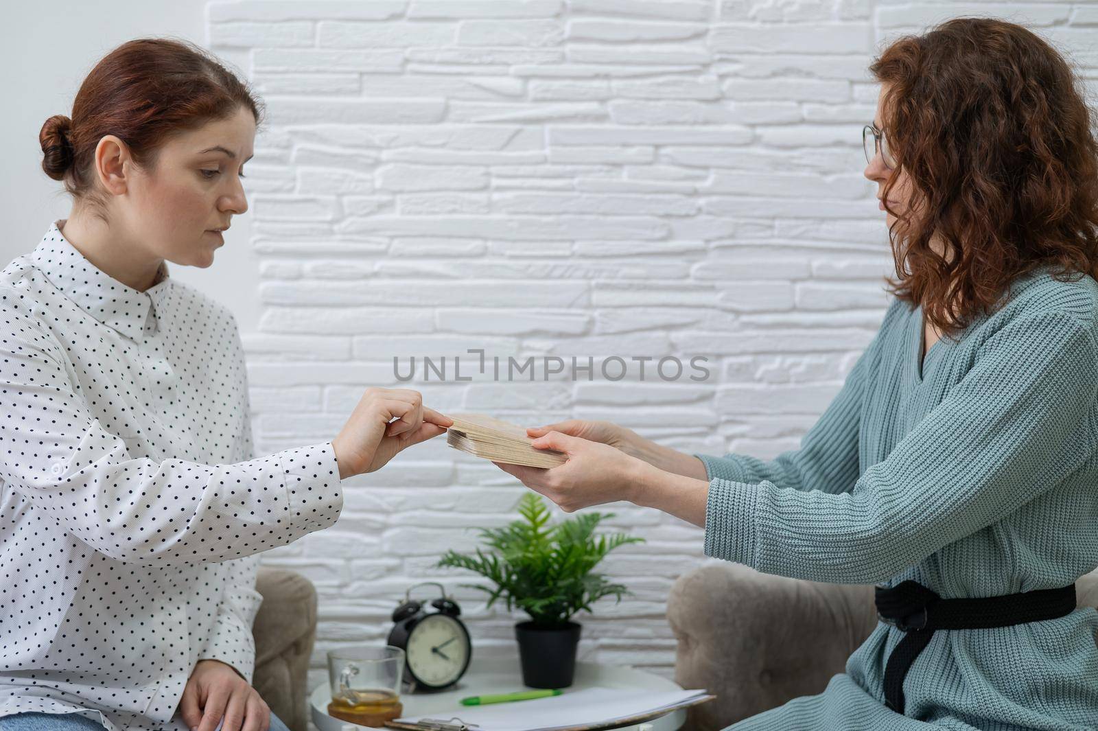 Psychologist uses metaphorical associative cards in a session with a patient