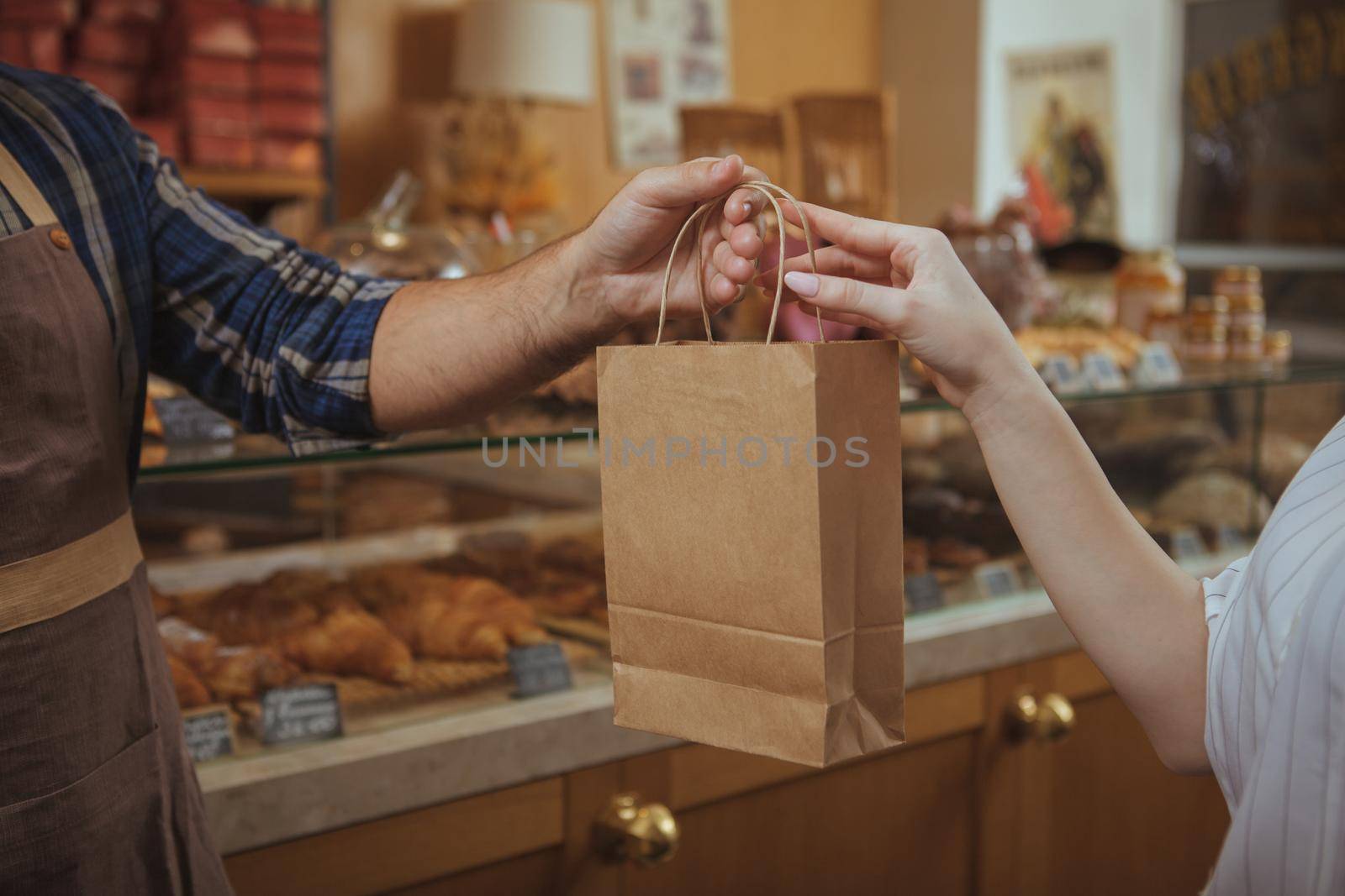 Attractive young woman shopping at bakery store by MAD_Production