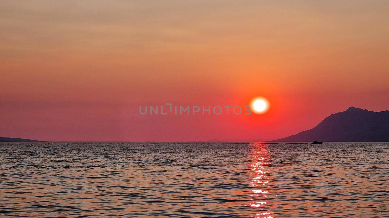 Beautiful red sunset over the Adriatic sea. Makarska Riviera-Biokovo, Dalmatia, Croatia, Europe.