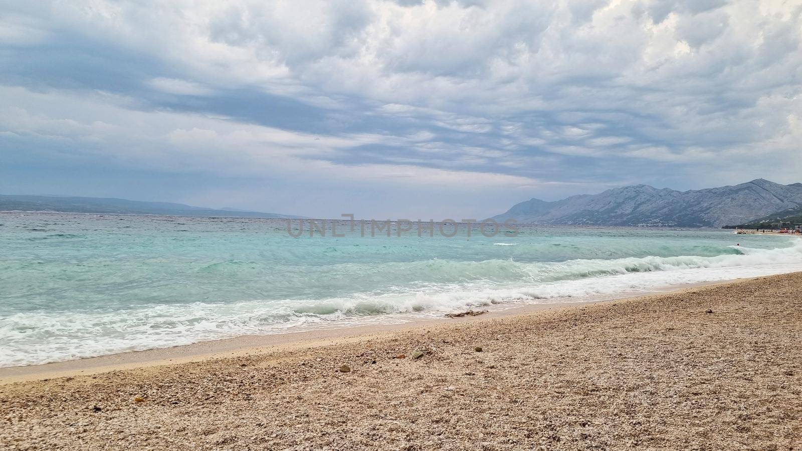 Beautiful shore of the Adriatic Sea. Bay view with cloudscape.