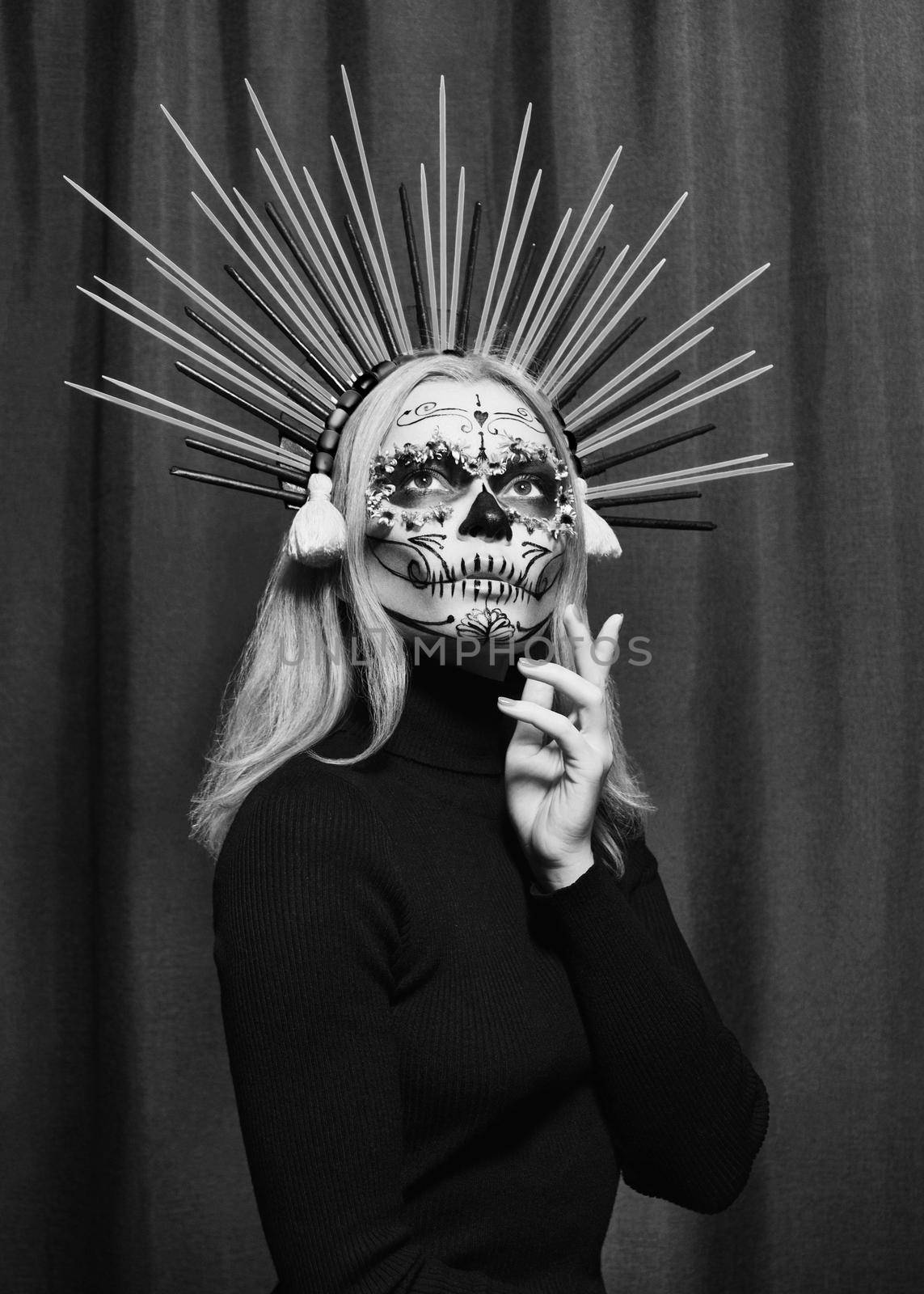 Beautiful Halloween Make-Up Style. Blond Model Wear Sugar Skull Makeup with Crown, pale Skin Tones and Waves Hair. Santa Muerte concept