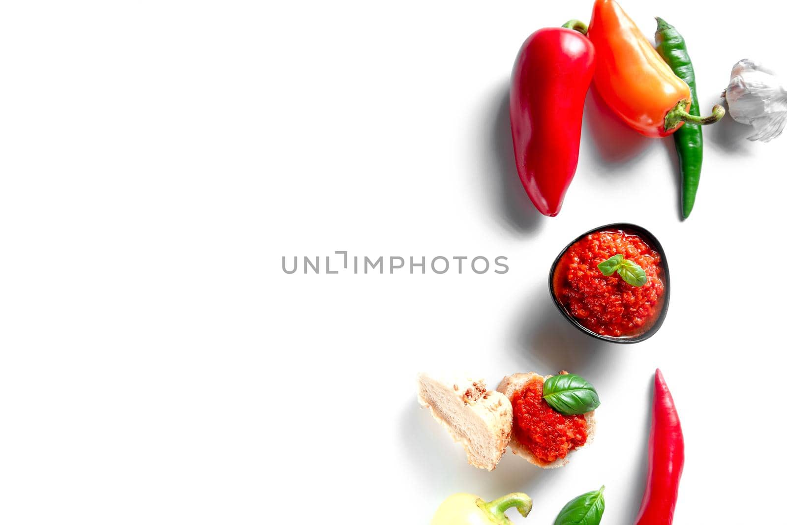 Ingredients for cooking Ajvar sauce. Place for the text. Ajvar is a locally known red pepper and eggplant seasoning that is produced in the Balkans - Turkey, Serbia, Montenegro, Albania and is vegan. by gulyaevstudio