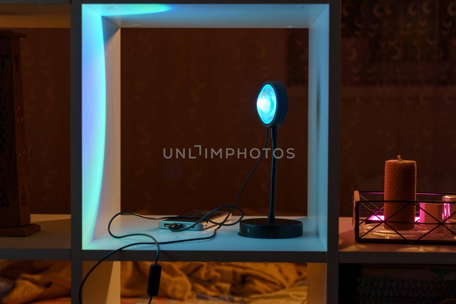 Sunset projector lamp on dark background. Home evening interior. Selective focus