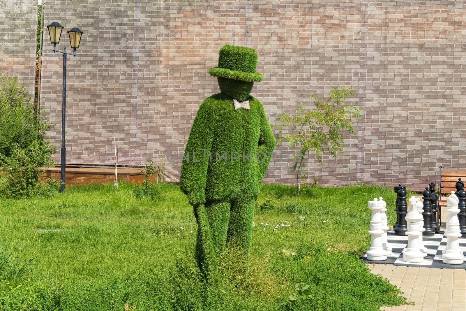 Figure man artificial grass, topiary. Selective focus, close-up. Copy space