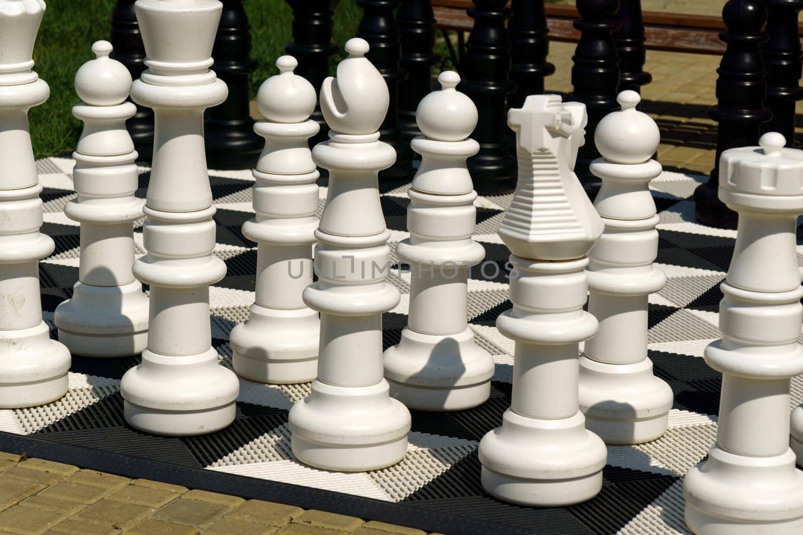 Big pieces and giant chess board of street chess in the park. Selective focus