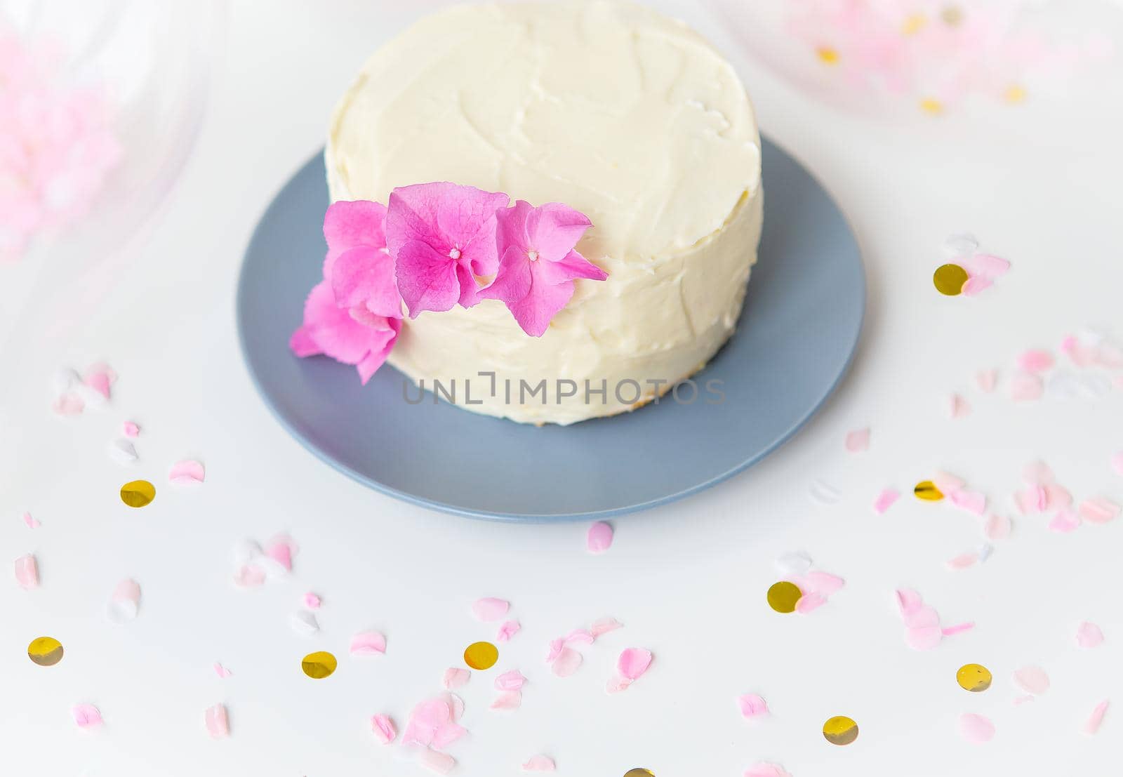 Very beautiful small white bento cake, decorated with fresh flowers of pink hydrangeas. Holiday and fun concept. by sfinks