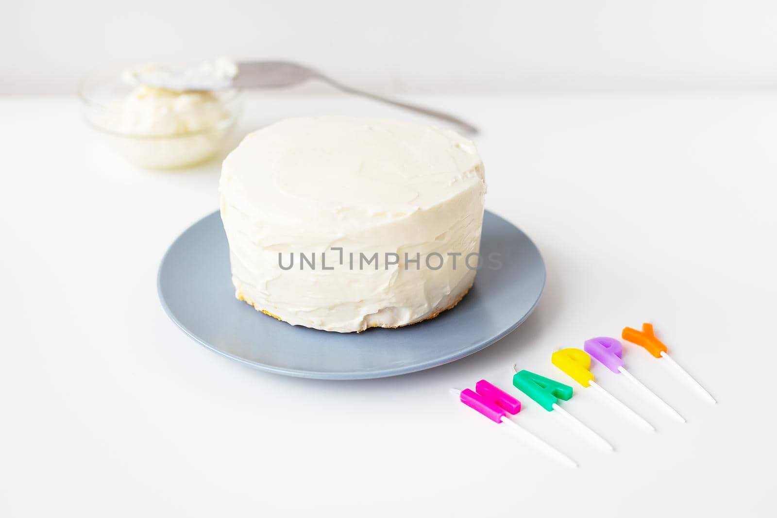 Preparing for a birthday cake, the inscription happiness on a creamy cookie. Surprise holiday and birthday concept. by sfinks